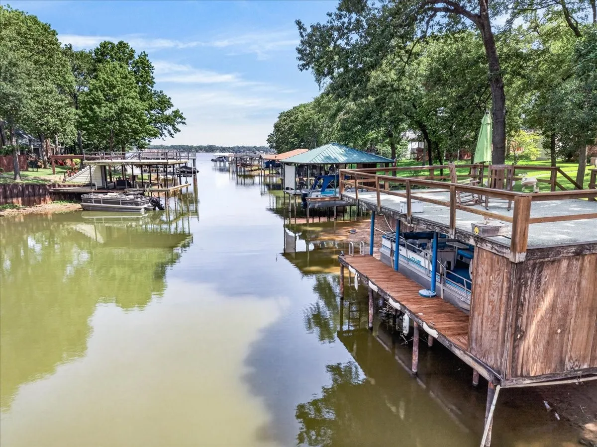 Channel view with direct water access - perfect for fishing, swimming, and paddle boarding. Water levels fluctuate - the lake will fill up - it always does.  Even on low lake level seasons - we all manage to have fun. These periodic seasons give owners time to maintain their boathouses and walls along with clean up shorelines and repair irrigation pvc lines which water your yard.