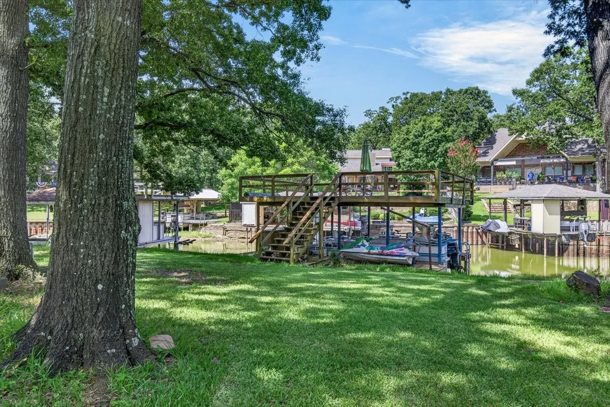 Lakeside Yard and double deck boathouse.  The mature shade trees are a huge plus during hot summers.