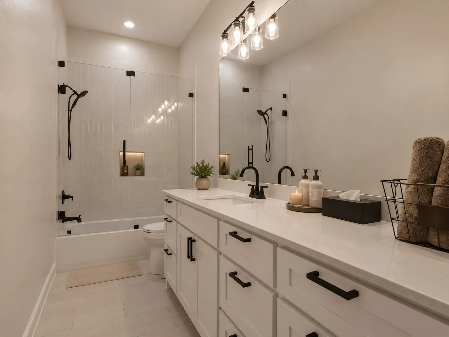 Double vanity with white cabinetry, matte black hardware, and an expansive countertop