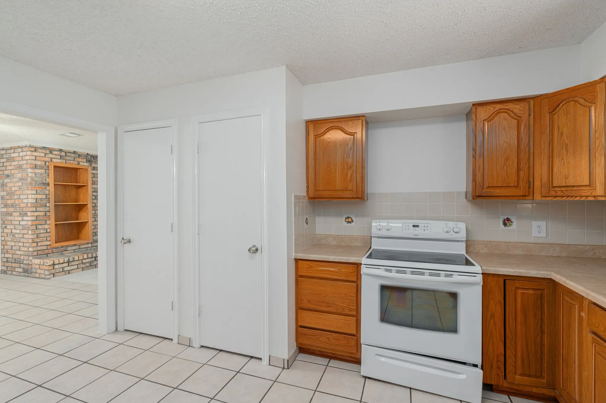 Additional cabinetry, pantry storage, and abundant workspace provide excellent functionality for everyday living.