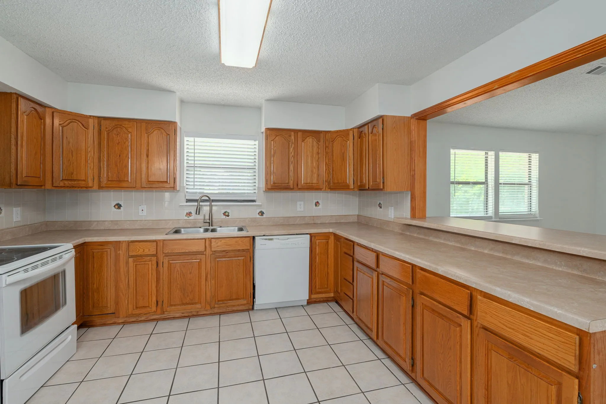 Generous cabinet storage, ample counter space, and an open serving bar make meal preparation a breeze.