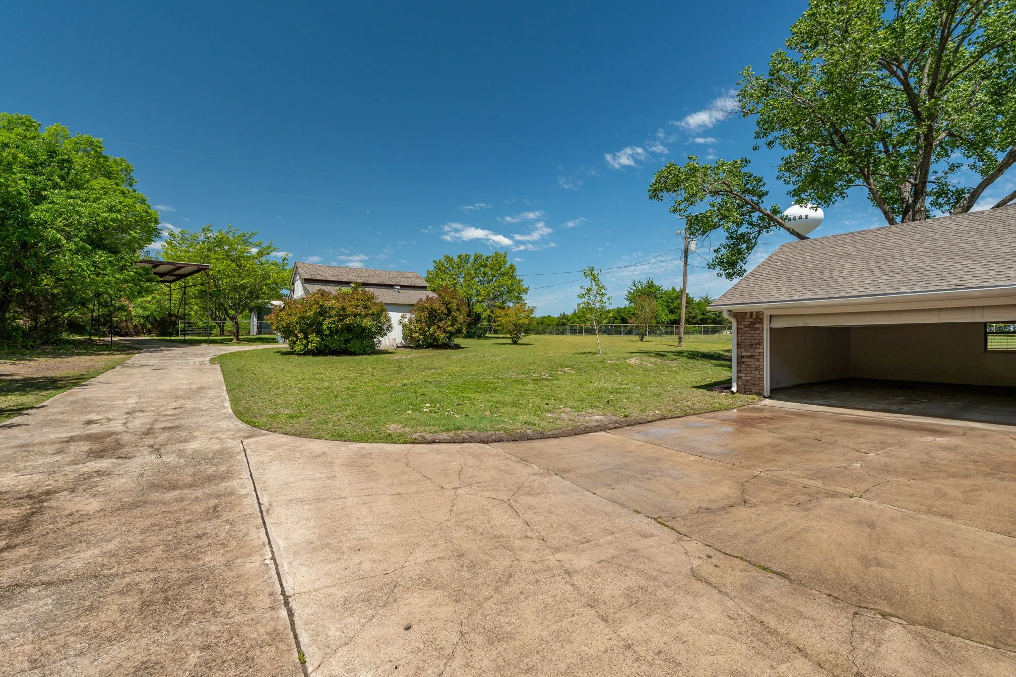 Long concrete driveway, including covered RV parking, and lots of room for additional parking, make everyday convenience e