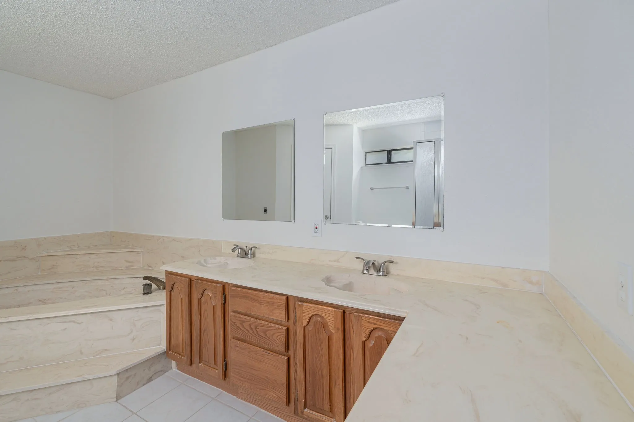 Expansive double vanity with abundant countertop space provides convenience for busy mornings and everyday living.