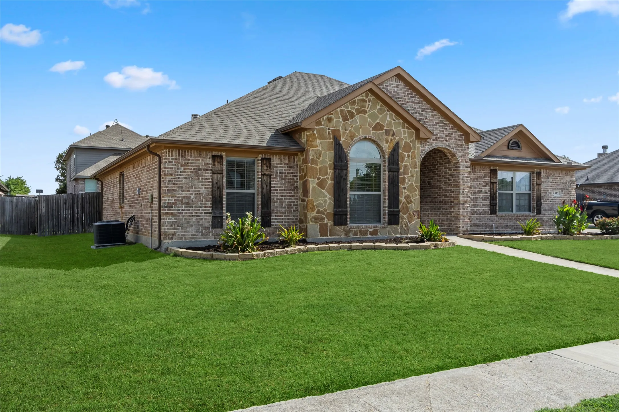 Brick and stone veneer exterior with arched entry