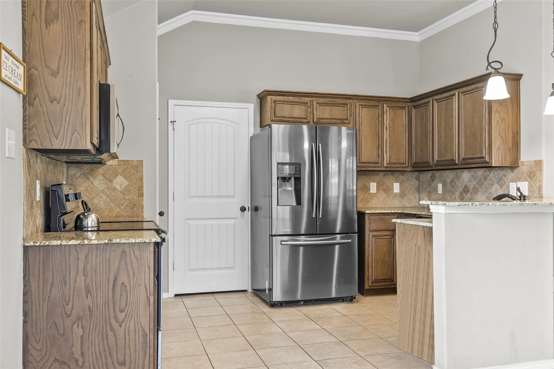 Kitchen featuring wood cabinetry, granite-style countertops, and a tiled backsplash
