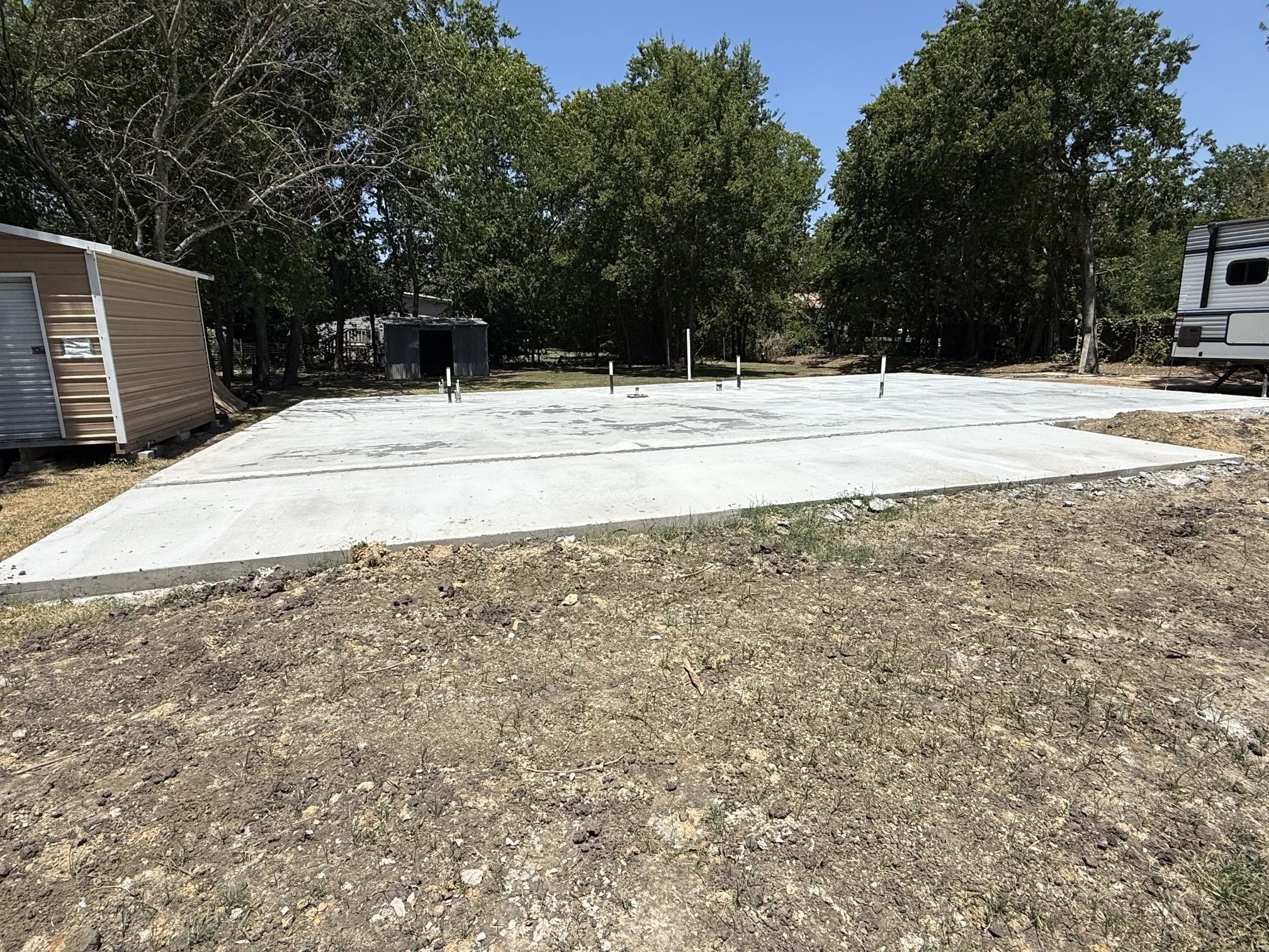 Concrete slab foundation with integrated plumbing risers