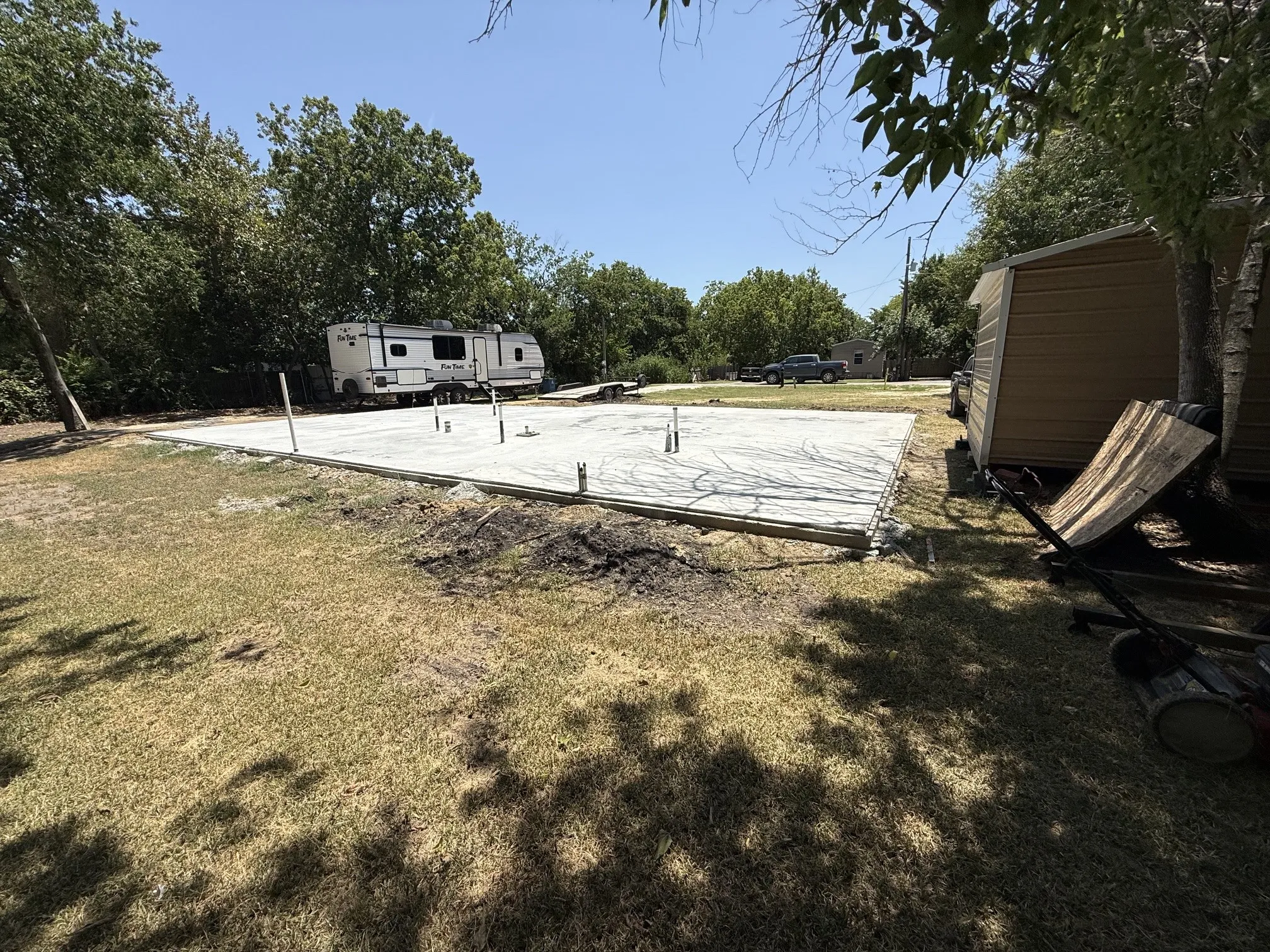 Newly poured concrete foundation featuring plumbing rough-ins
