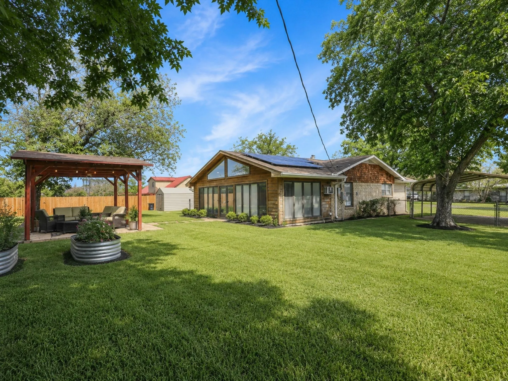 The expansive backyard offers room to entertain, garden, play, or simply unwind beneath mature trees—all just minutes from Lake Texoma.
