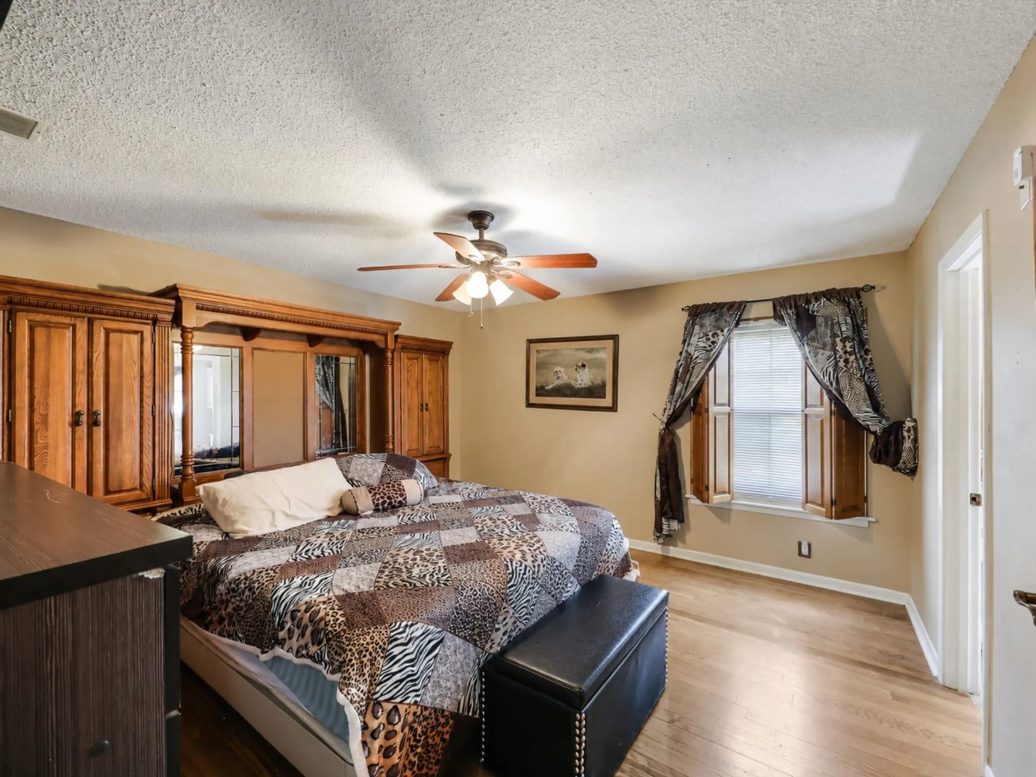The oversized primary suite offers exceptional space, abundant natural light, and plenty of room to create your own private retreat.