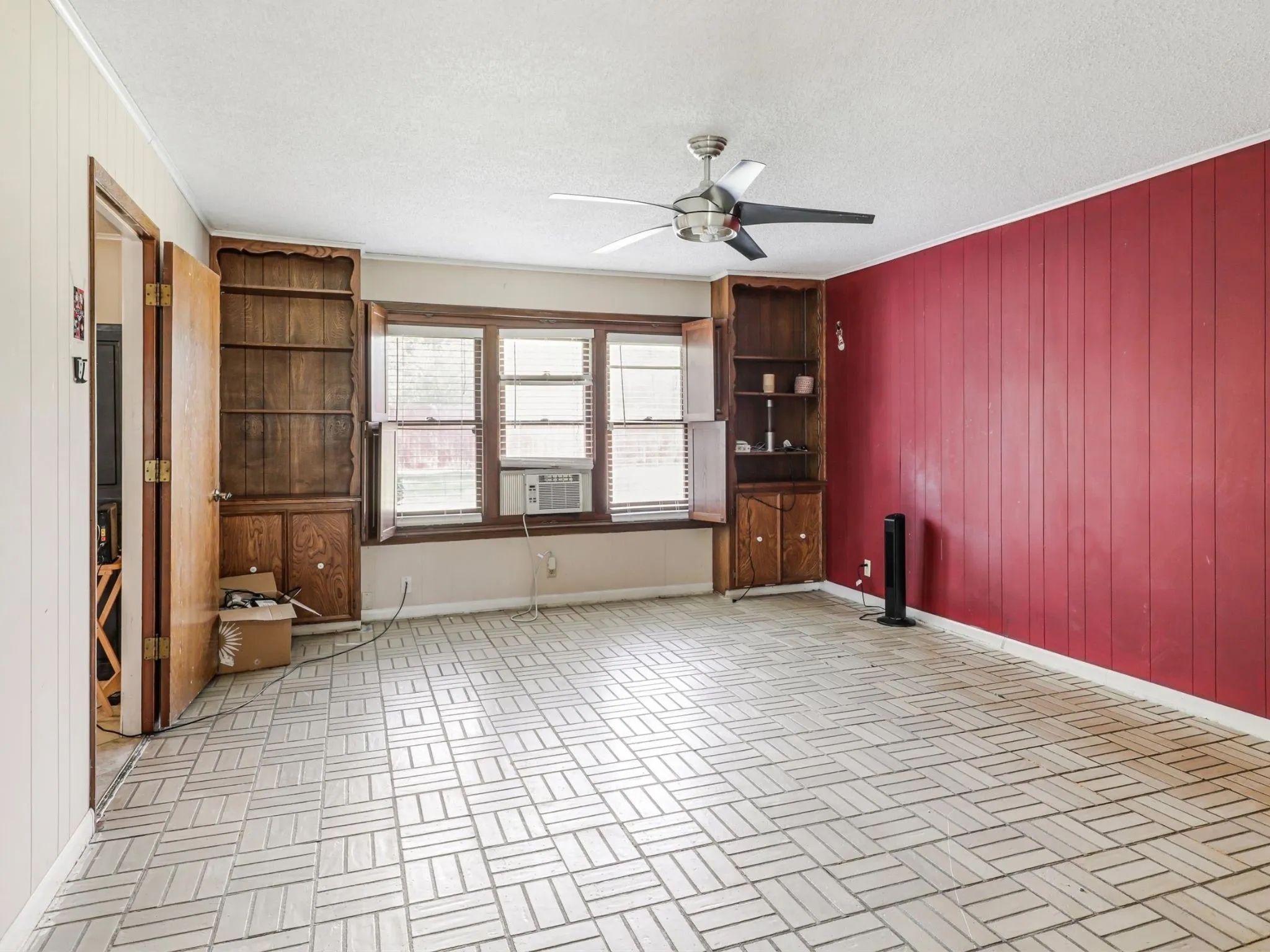 This spacious second living area features custom built-ins and large windows, providing the perfect canvas for a media room, game room, or relaxing family retreat.
