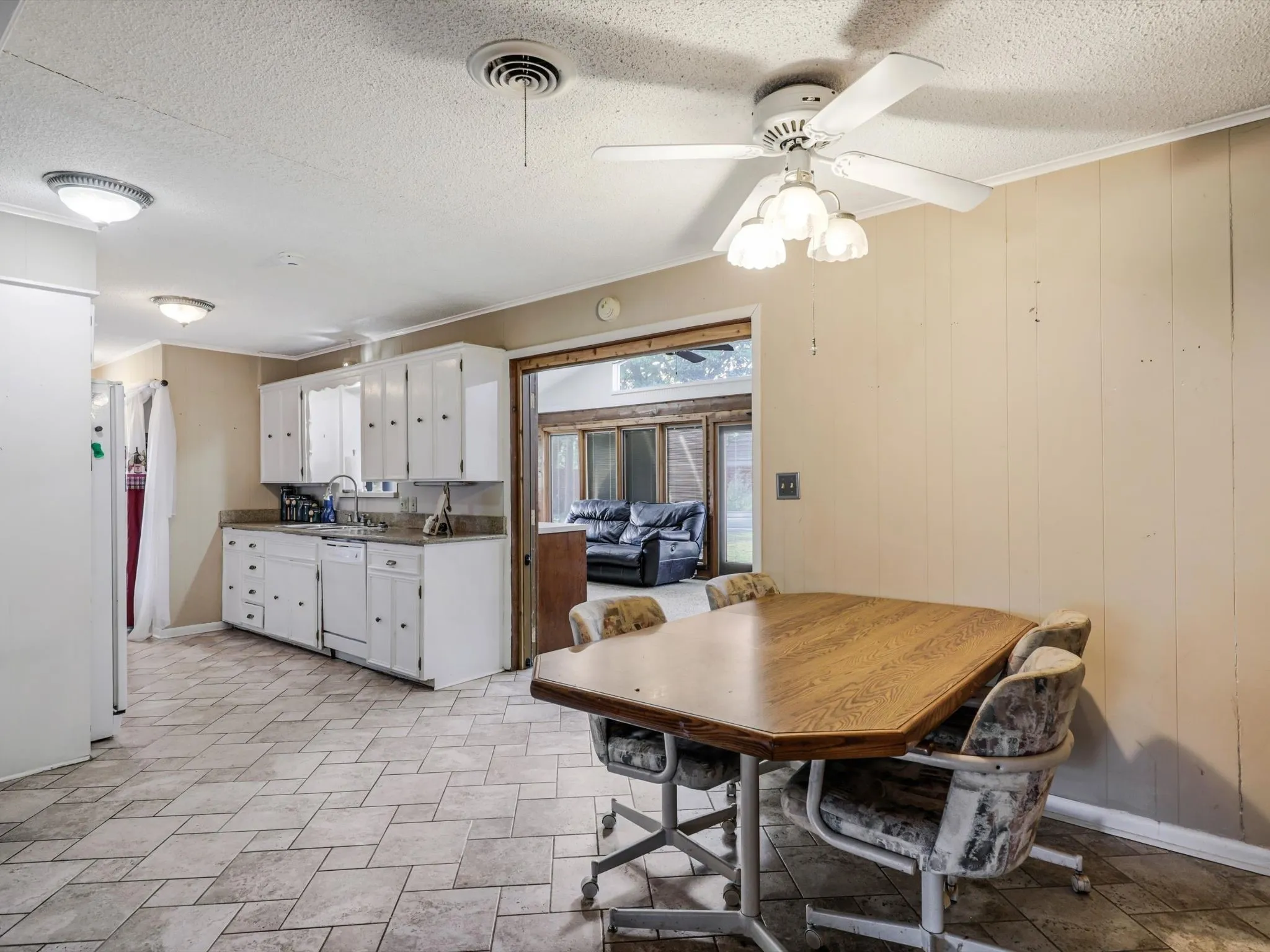 The breakfast room offers everyday convenience with easy access to the kitchen and stunning sunroom beyond.