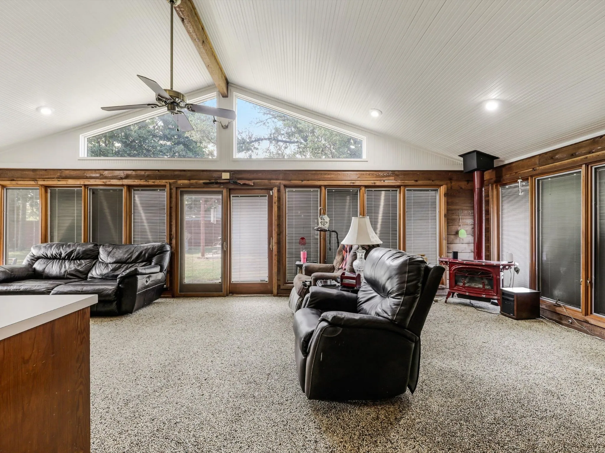 The dramatic vaulted ceiling, expansive windows, and warm wood finishes create an unforgettable living space filled with natural light.