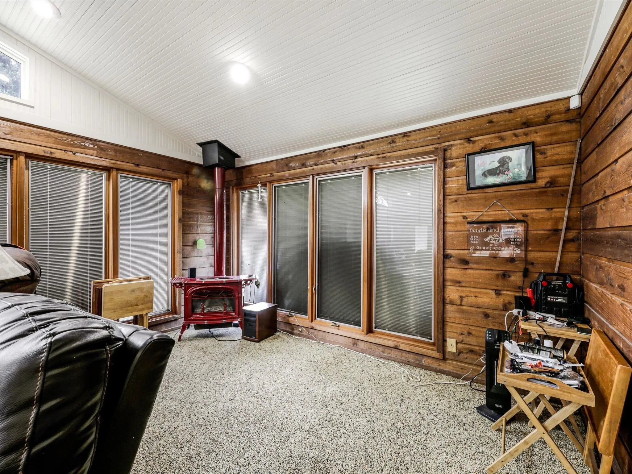 Walls of windows, soaring ceilings, and rich wood accents make this one of the home's most unique spaces, bringing the outdoors inside year-round.