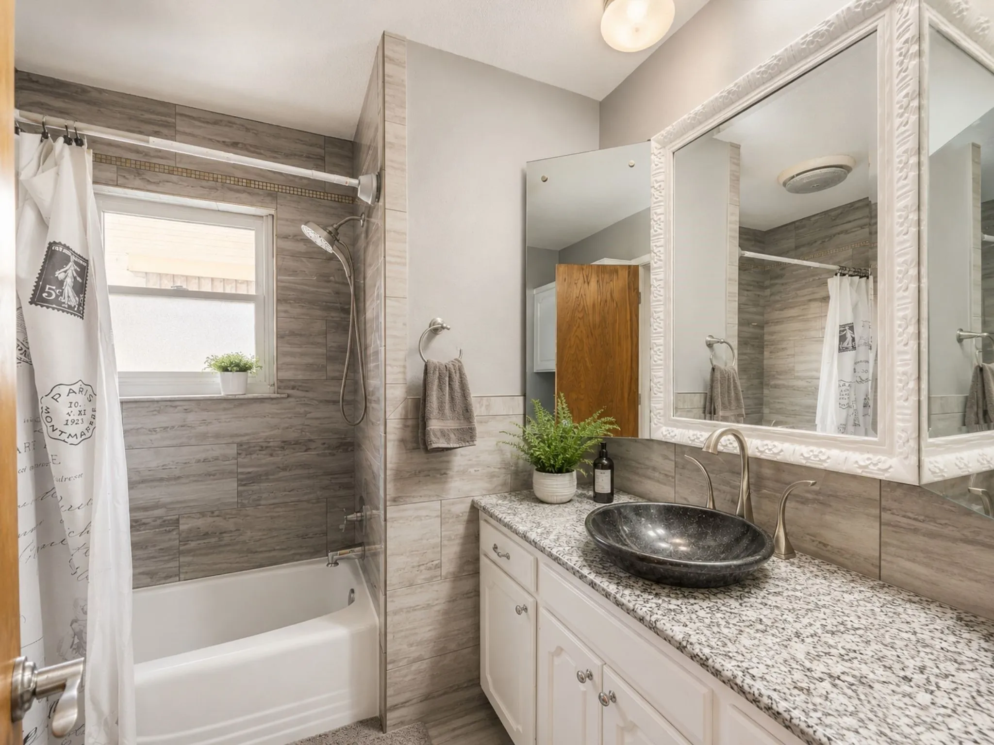 Already beautifully updated, this bathroom features granite countertops, stylish tile work, and modern finishes that are ready to enjoy from day one.