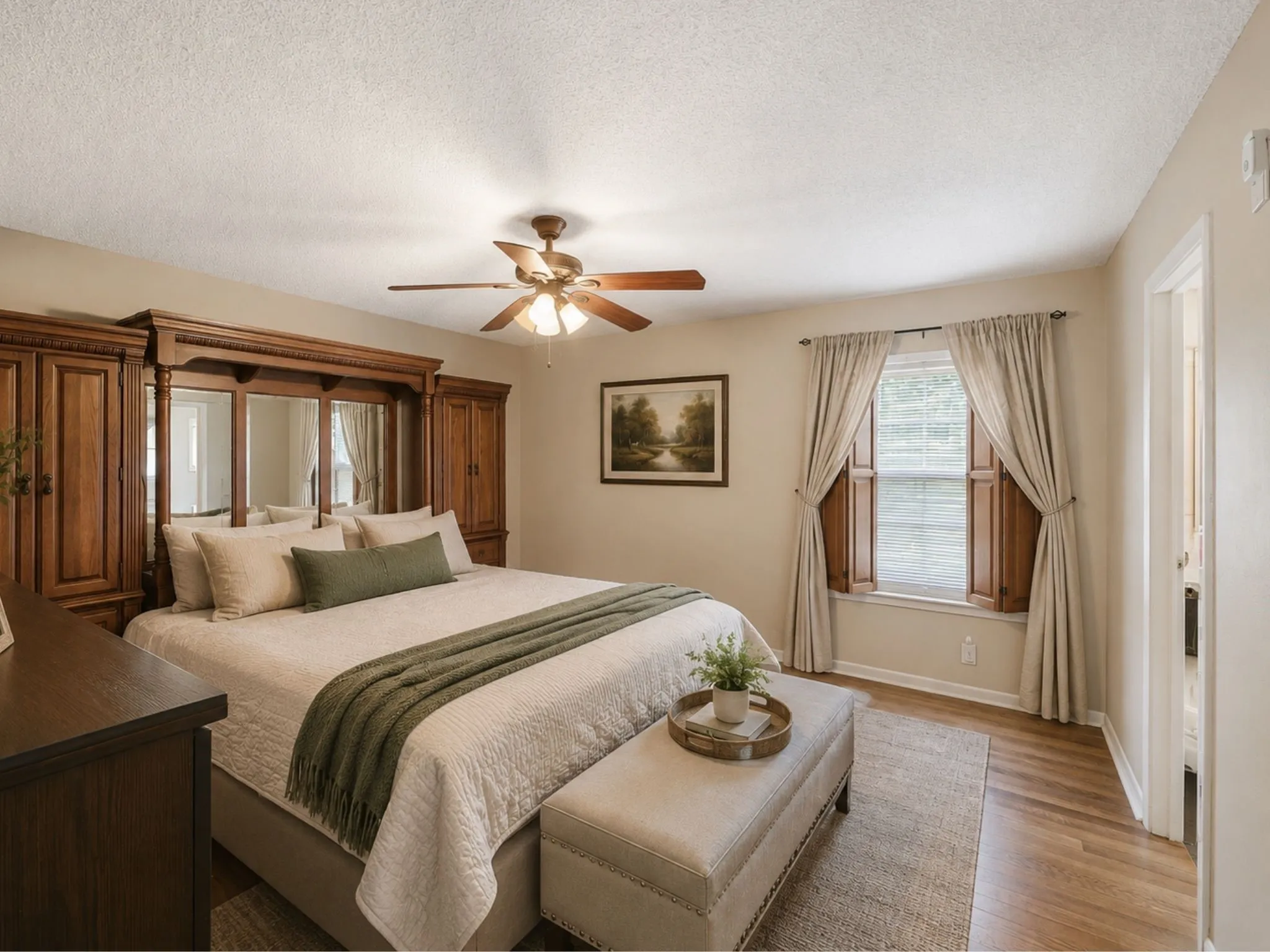 Fresh paint, soft furnishings, and updated window treatments completely change the atmosphere—showing just how easily this room can become a peaceful owner's retreat.
