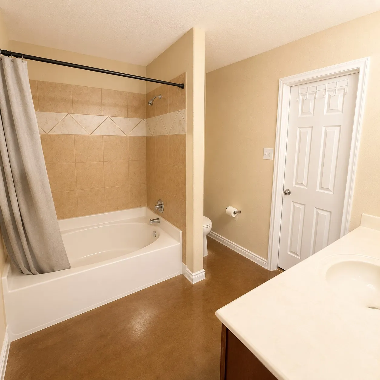 Bathroom featuring a combination shower and tub with neutral tile surround