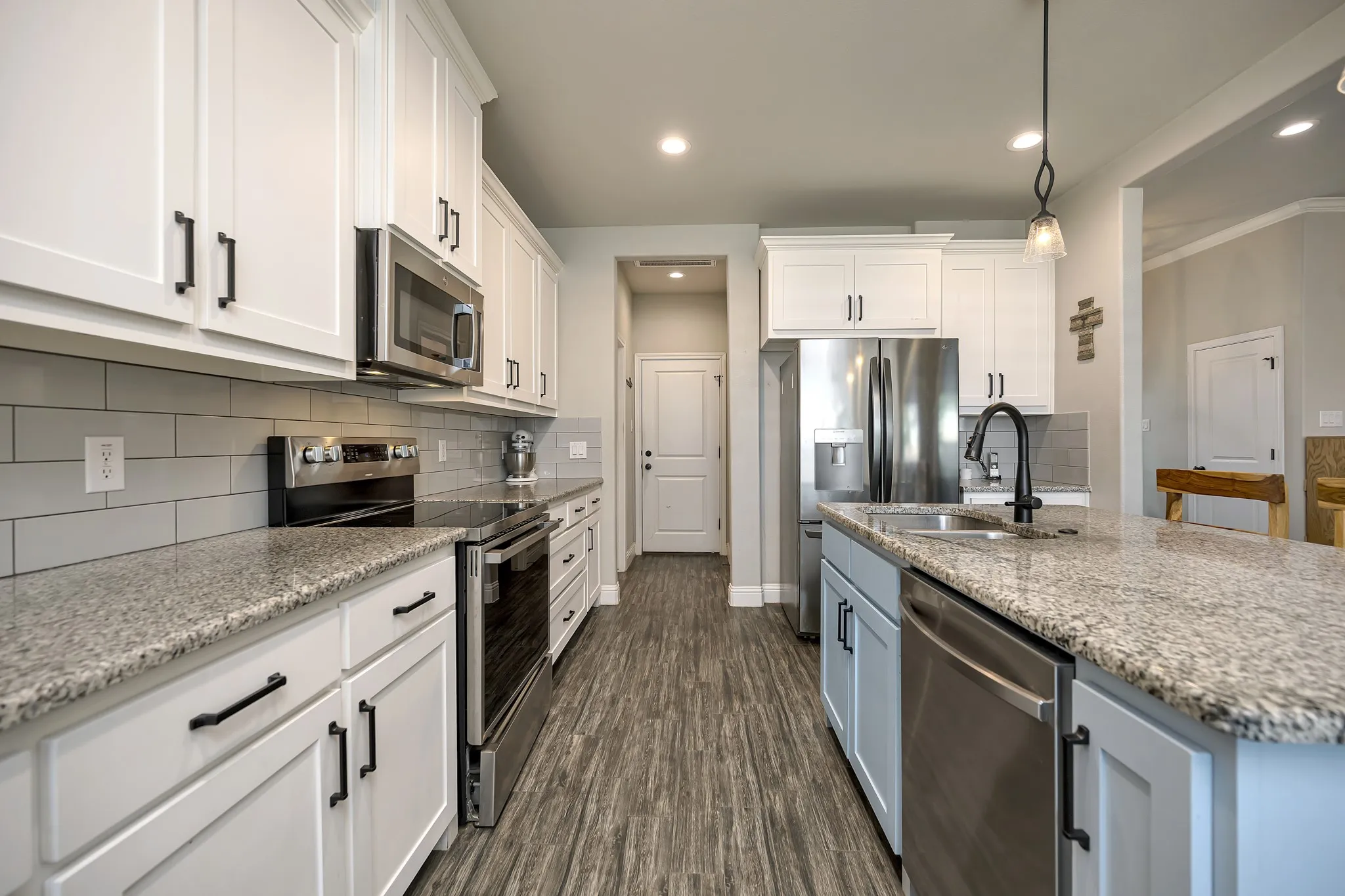 Another view from breakfast area into kitchen-laundry room is over to the back left and walk-in pantry to the back right.