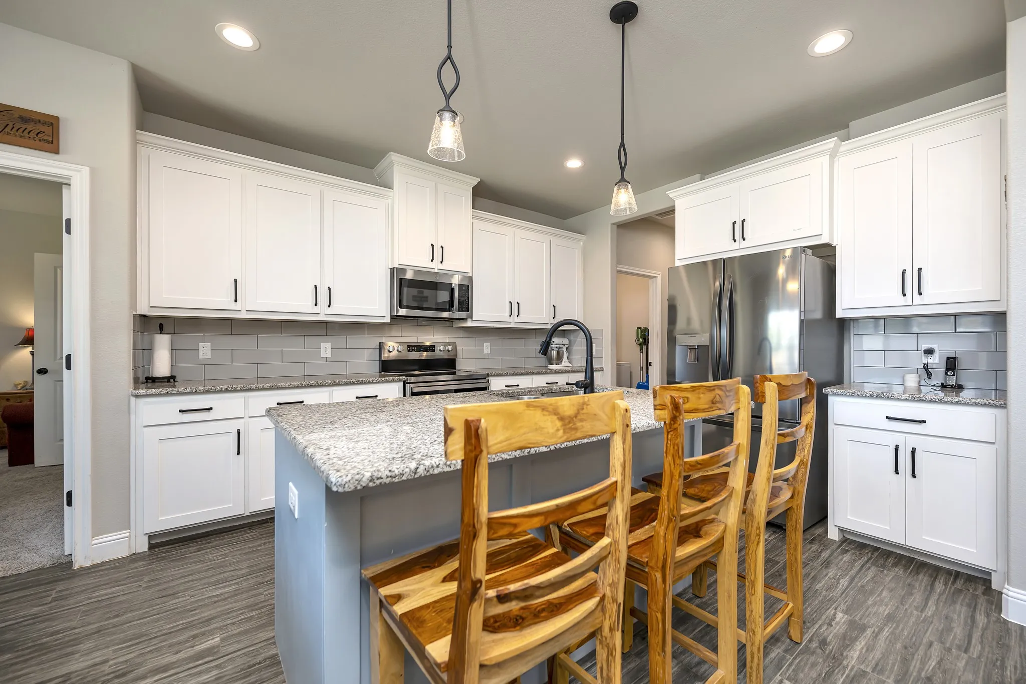 Farmhouse kitchen with massive island, shaker cabinets, stainless appliances and granite counters!