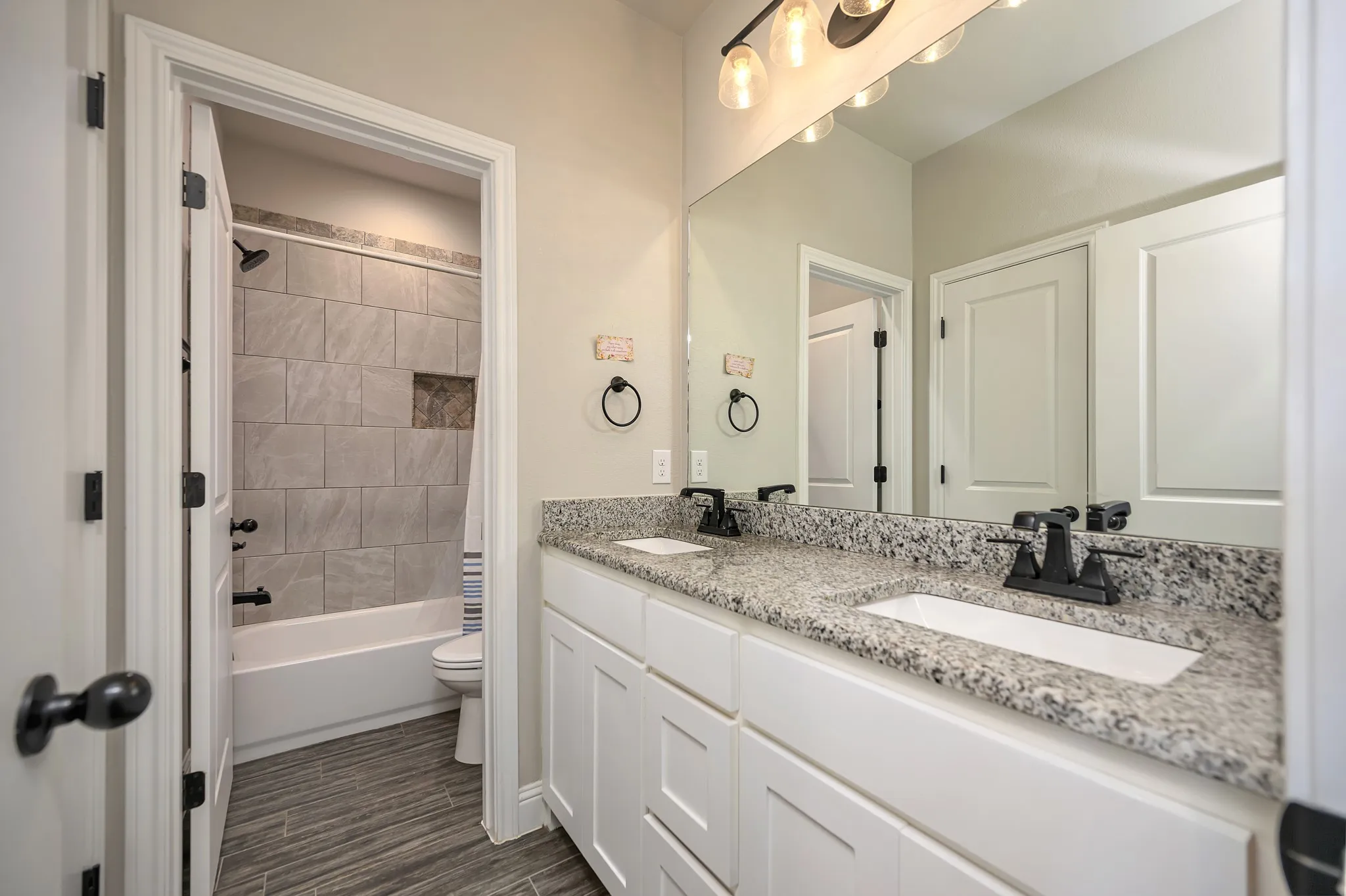 Full Bath 2 with double sinks and granite counters.