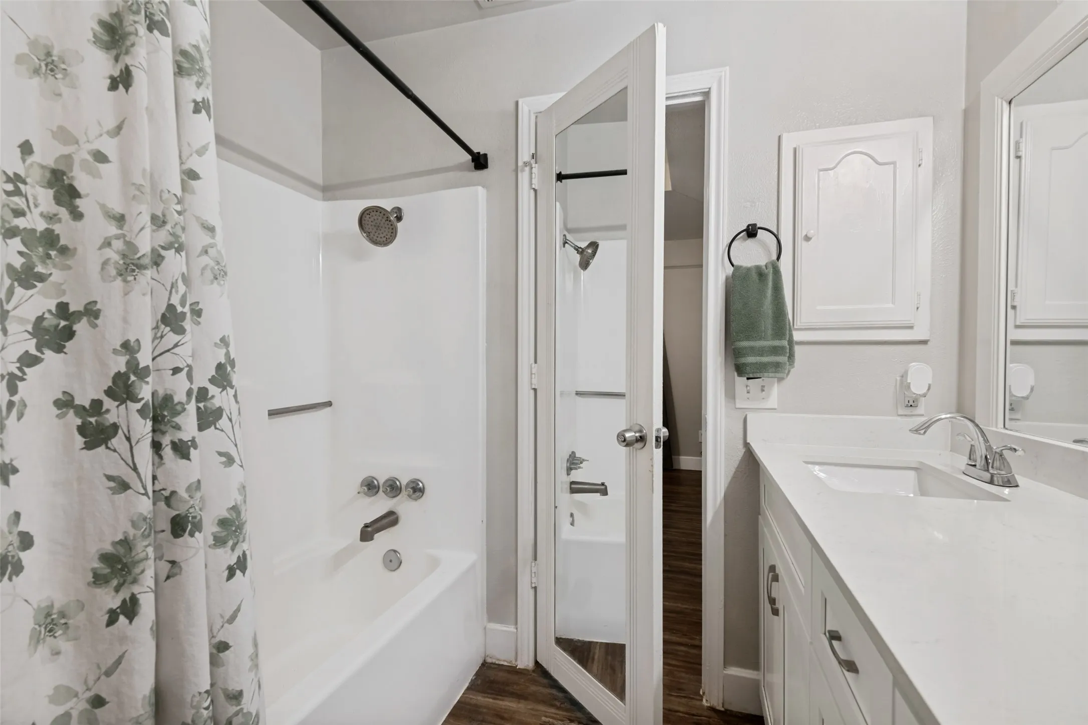 Full bathroom featuring a white vanity with an integrated sink, a bright white countertop, and a built-in medicine cabinet