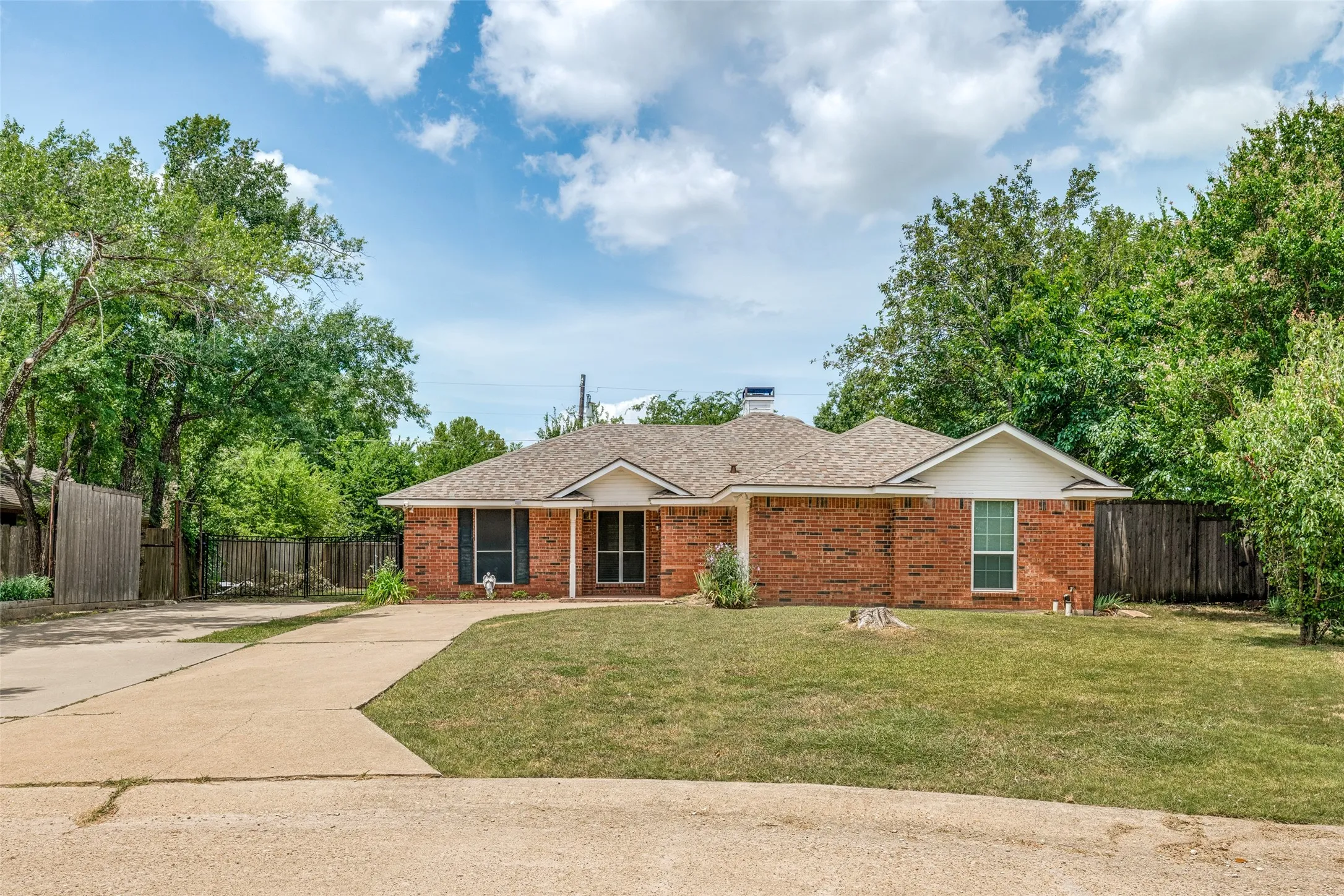 Brick exterior residence featuring a gabled roofline