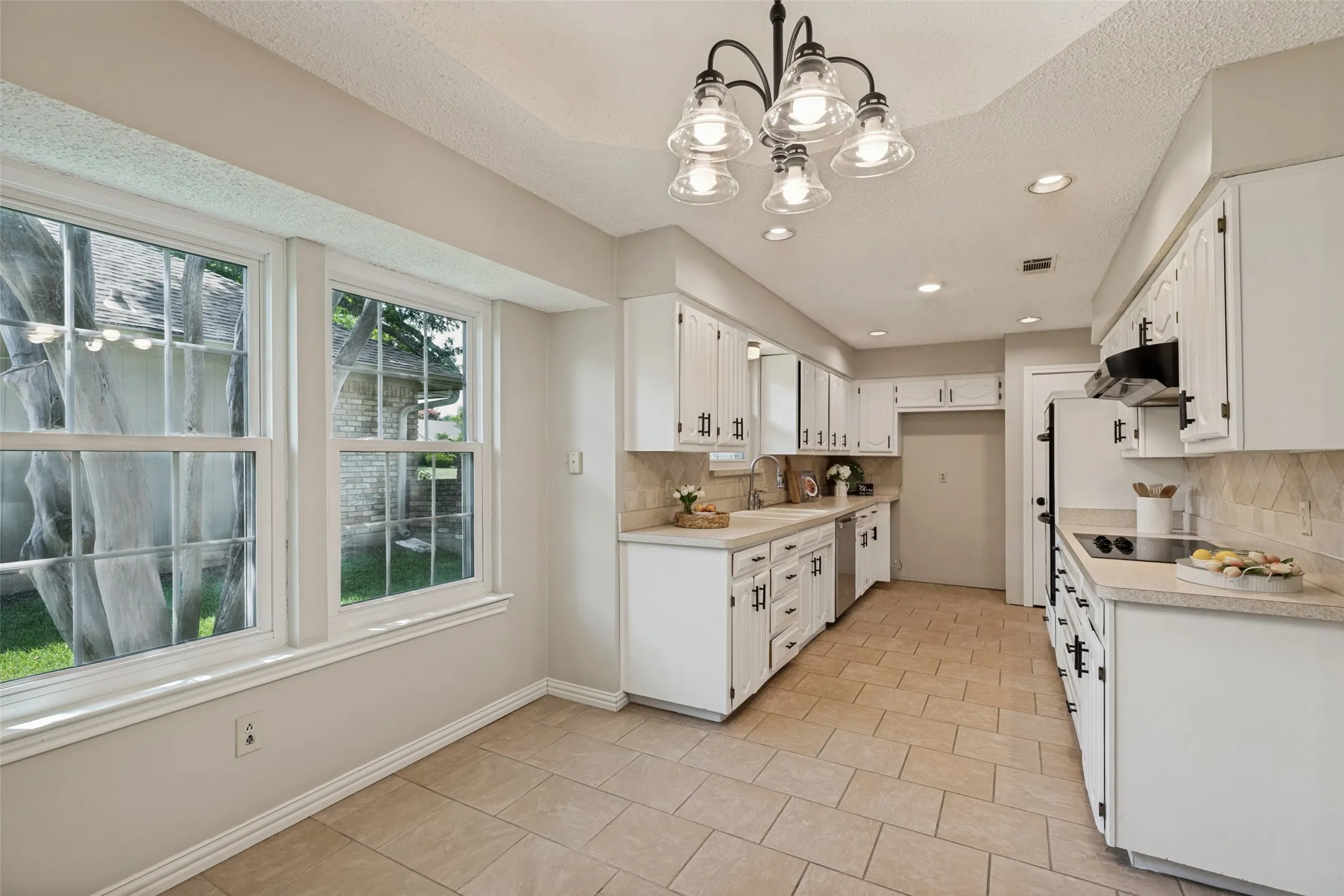 Light and bright kitchen with white cabinetry.