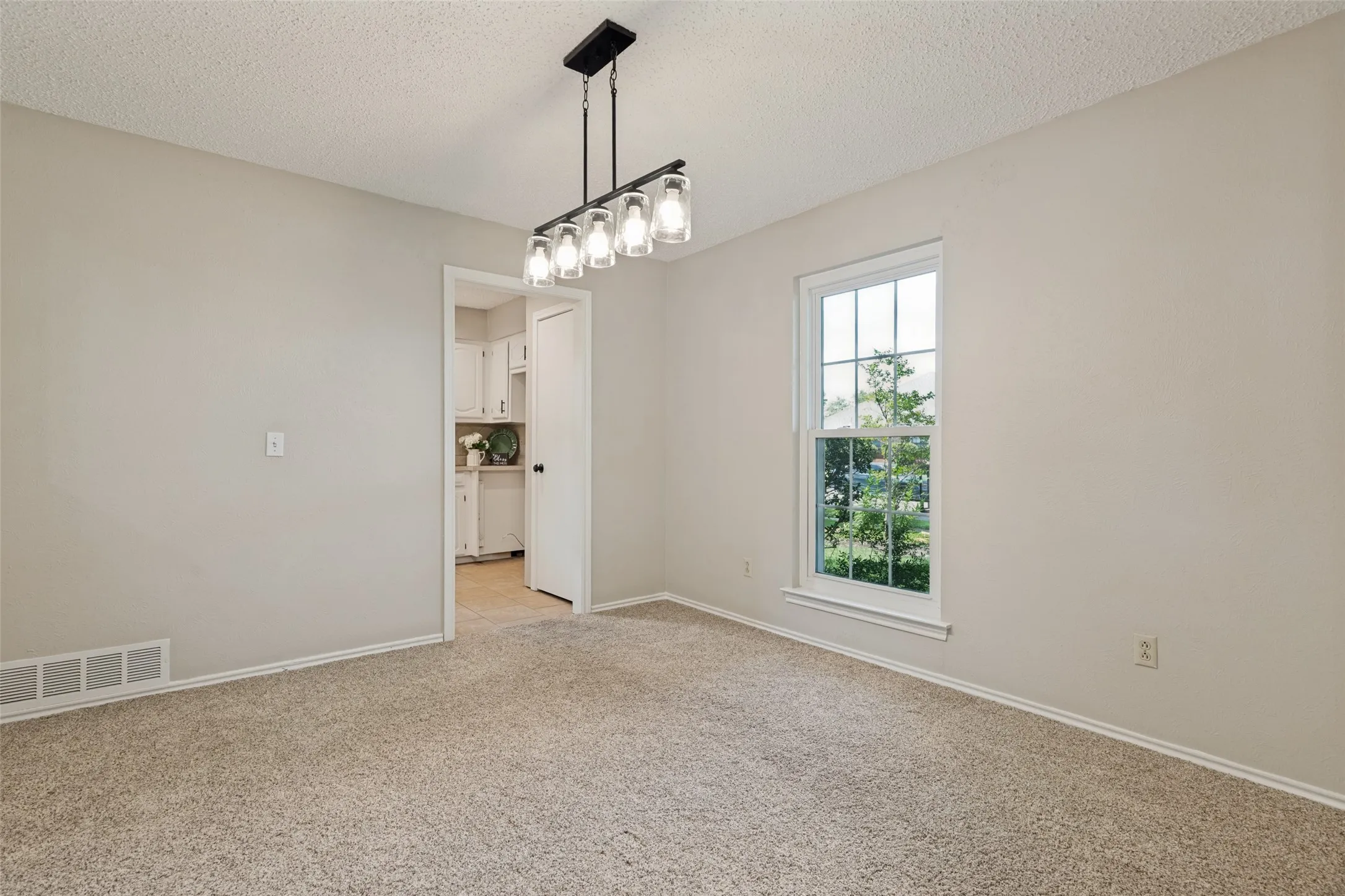 Beautiful dining room with light fixture.