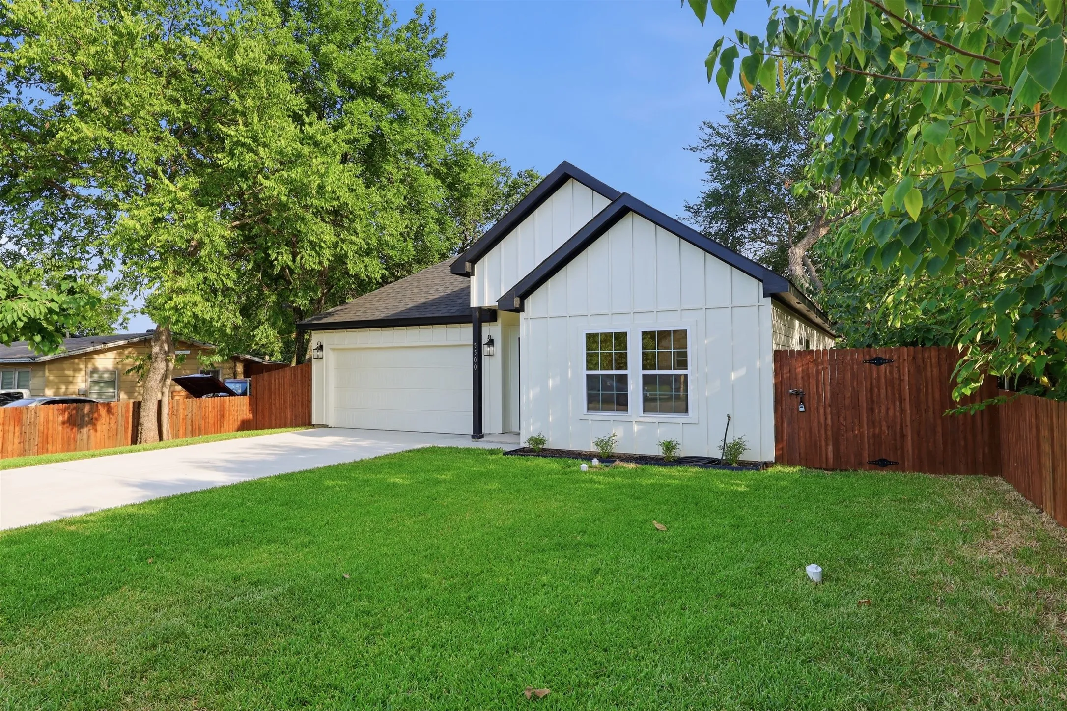 Crisp white board and batten exterior with black trim accents