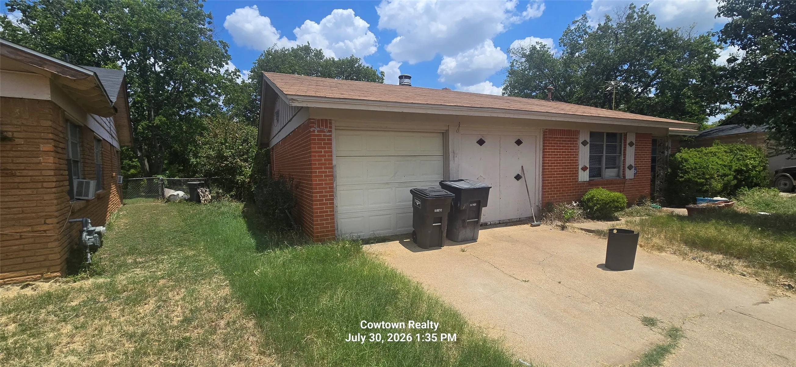 Brick exterior with a single-car garage and a paved driveway
