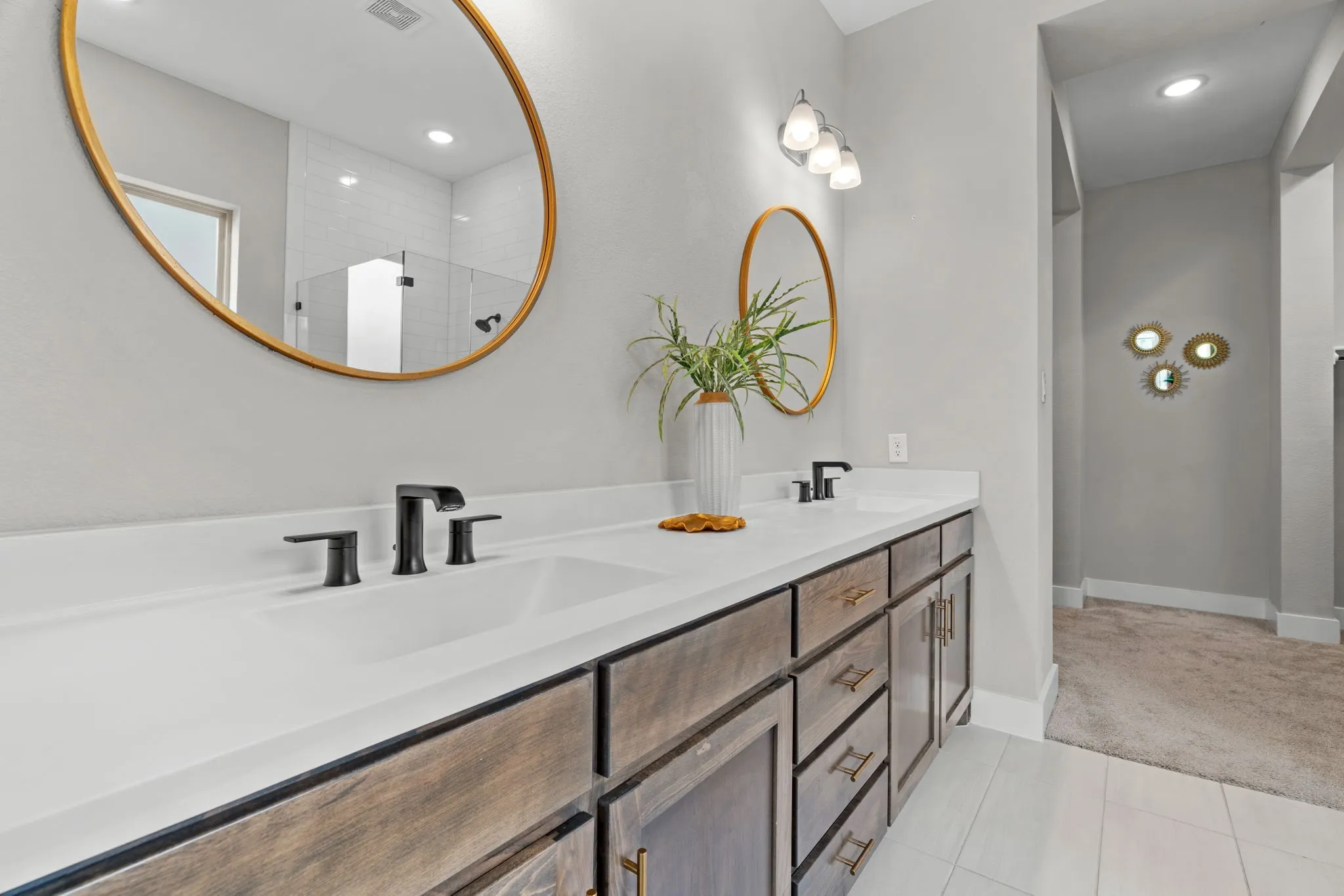 Dual vanity with white countertops, undermount sinks, and matte black fixtures