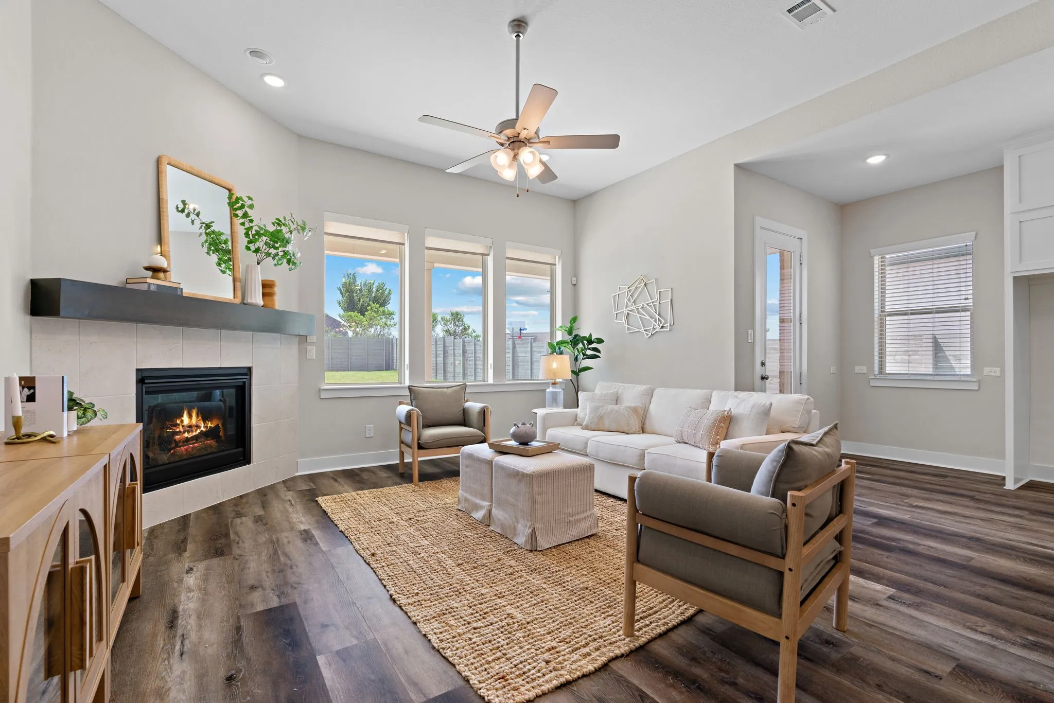 Living area featuring vaulted ceilings, recessed lighting, and wood-finish flooring