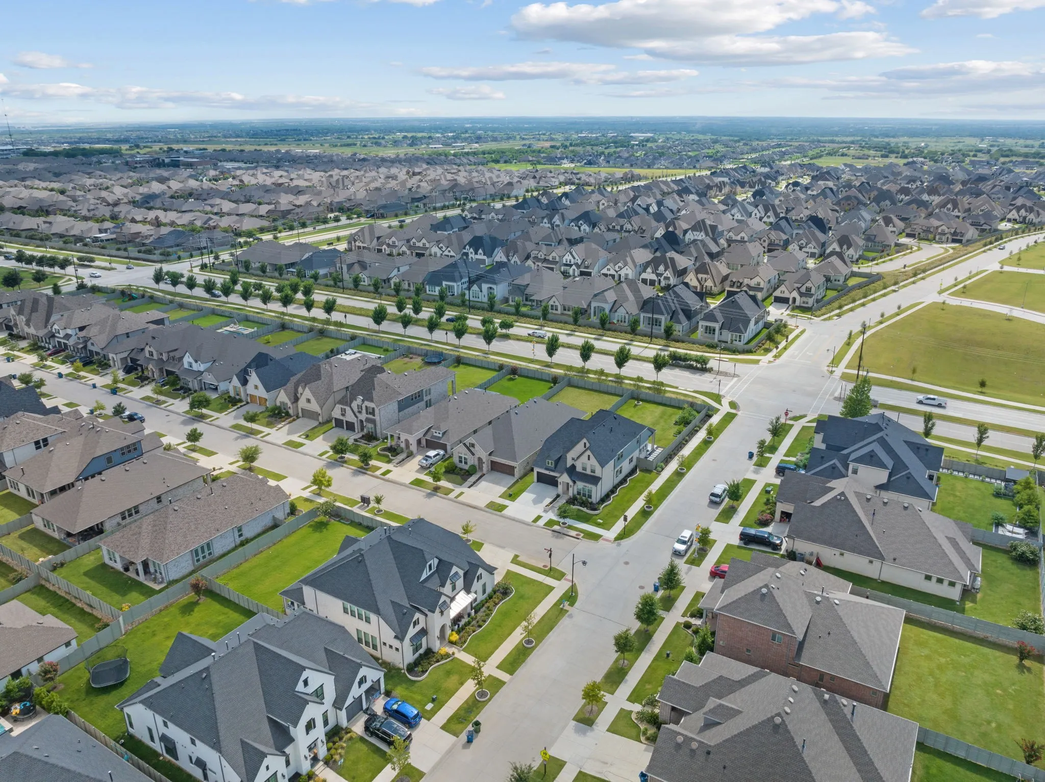 Aerial perspective of a developed residential community featuring consistent architectural styles