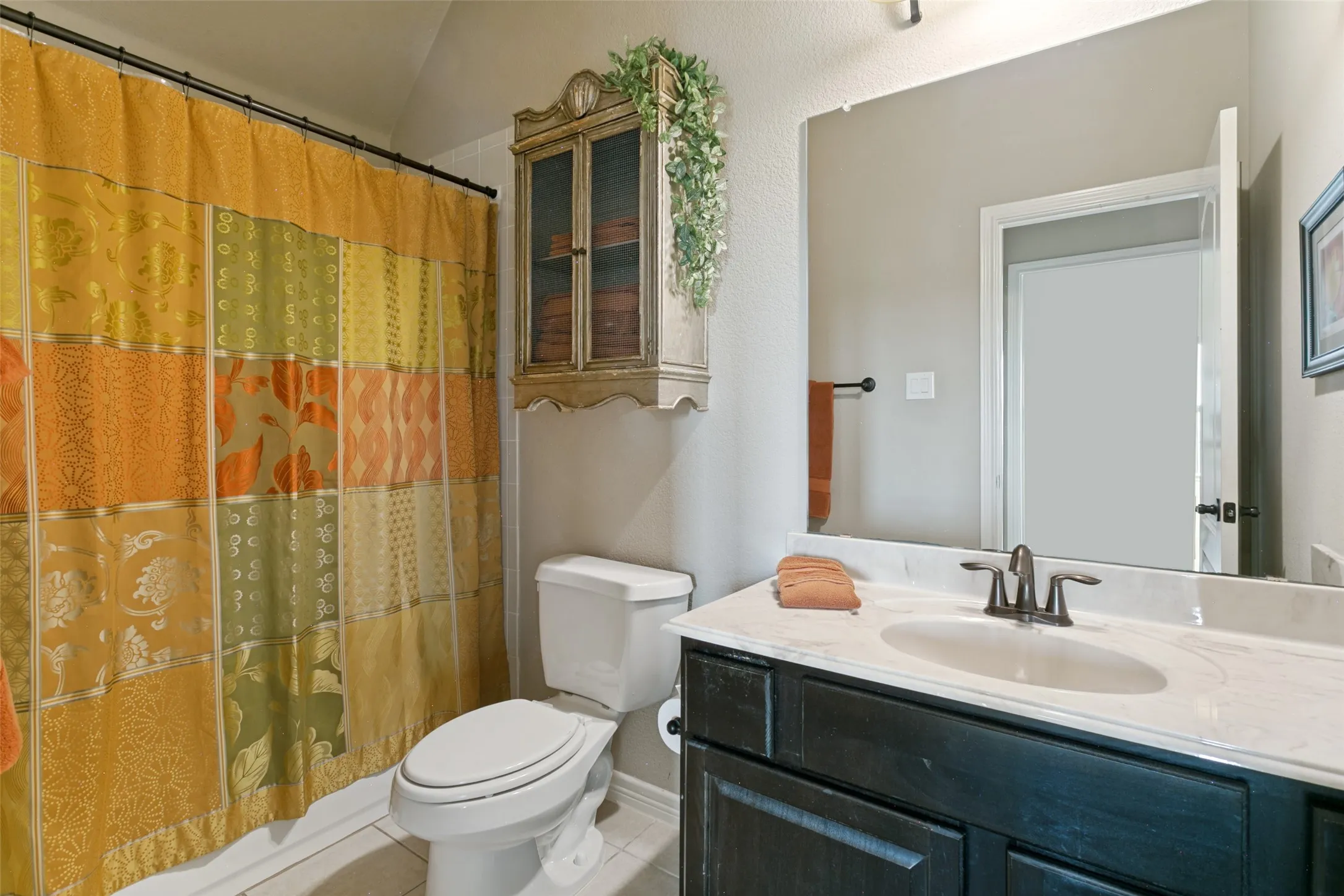 Spa-inspired bathroom featuring a dark wood vanity with white quartz countertop, and oil-rubbed bronze faucet