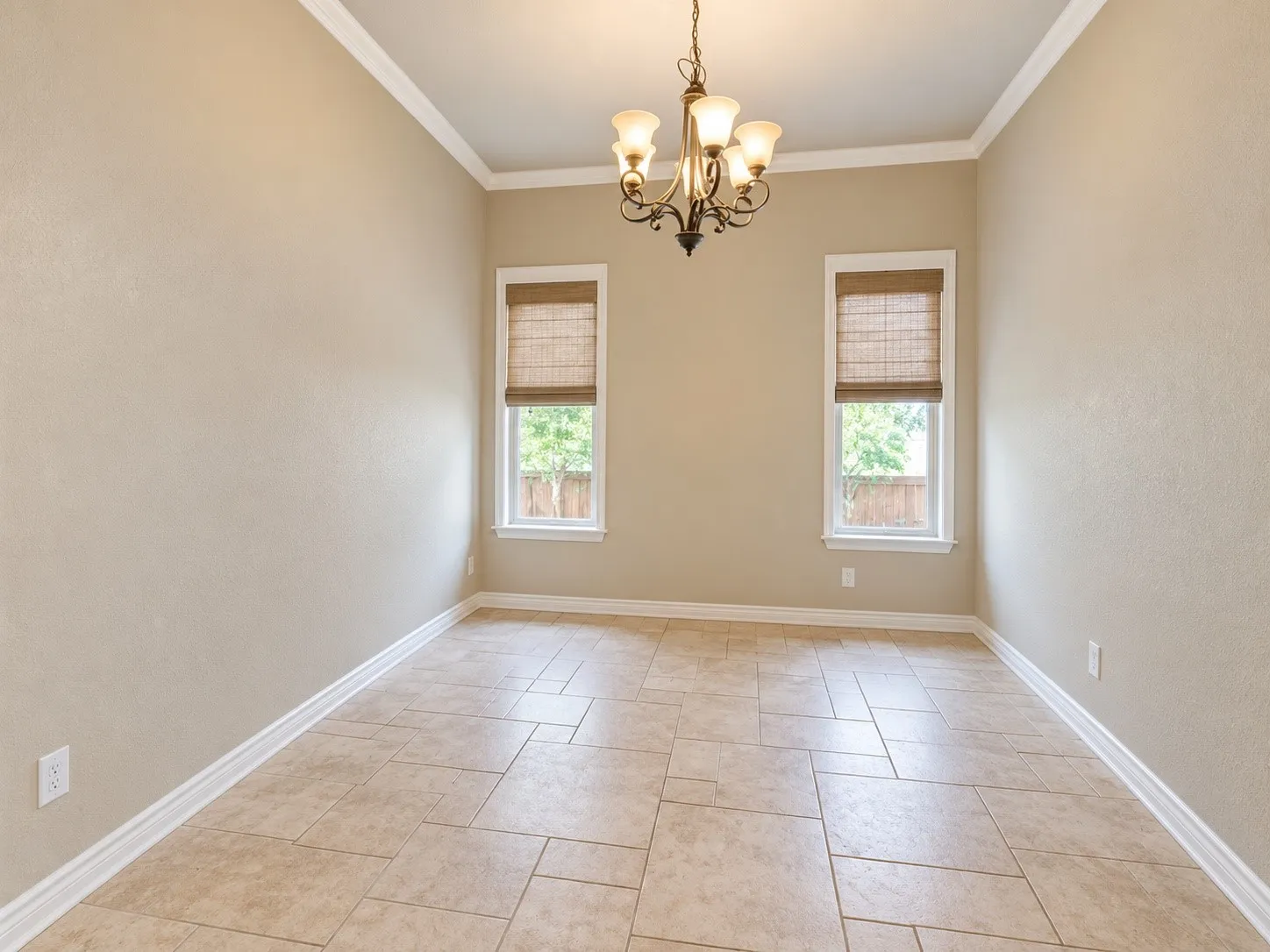 Bright and spacious dining room featuring neutral wall finishes, crown molding, and recessed ceiling detail