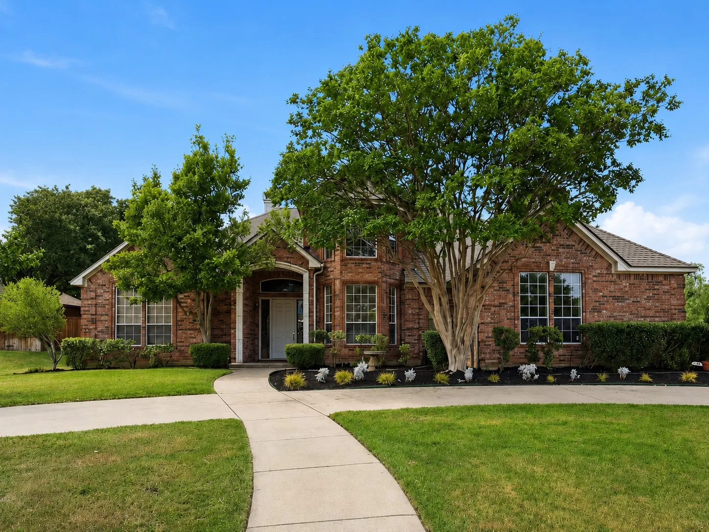 Brick exterior with multiple gables and a covered entry