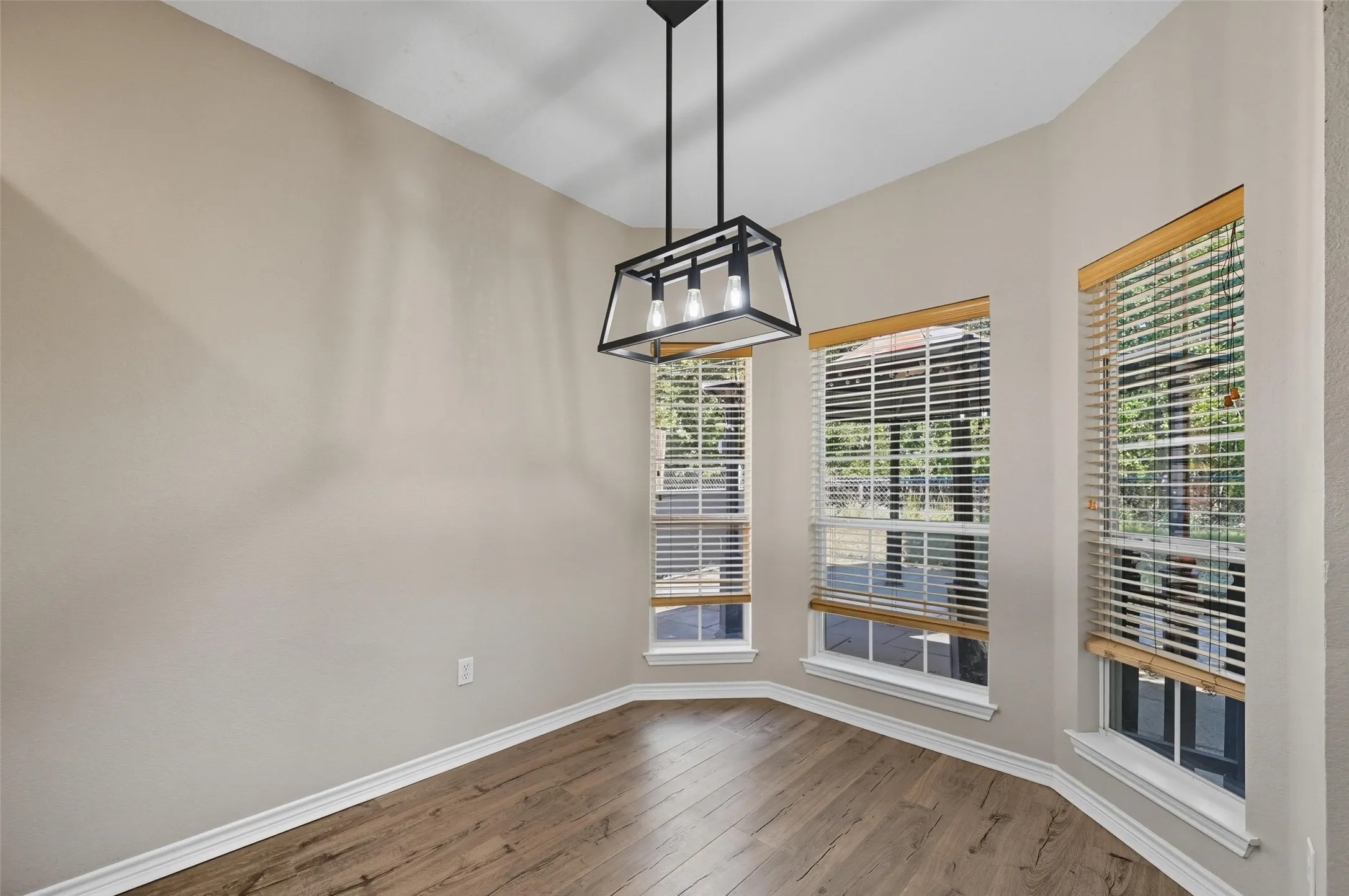 Unfurnished dining area featuring plenty of natural light and wood-type flooring