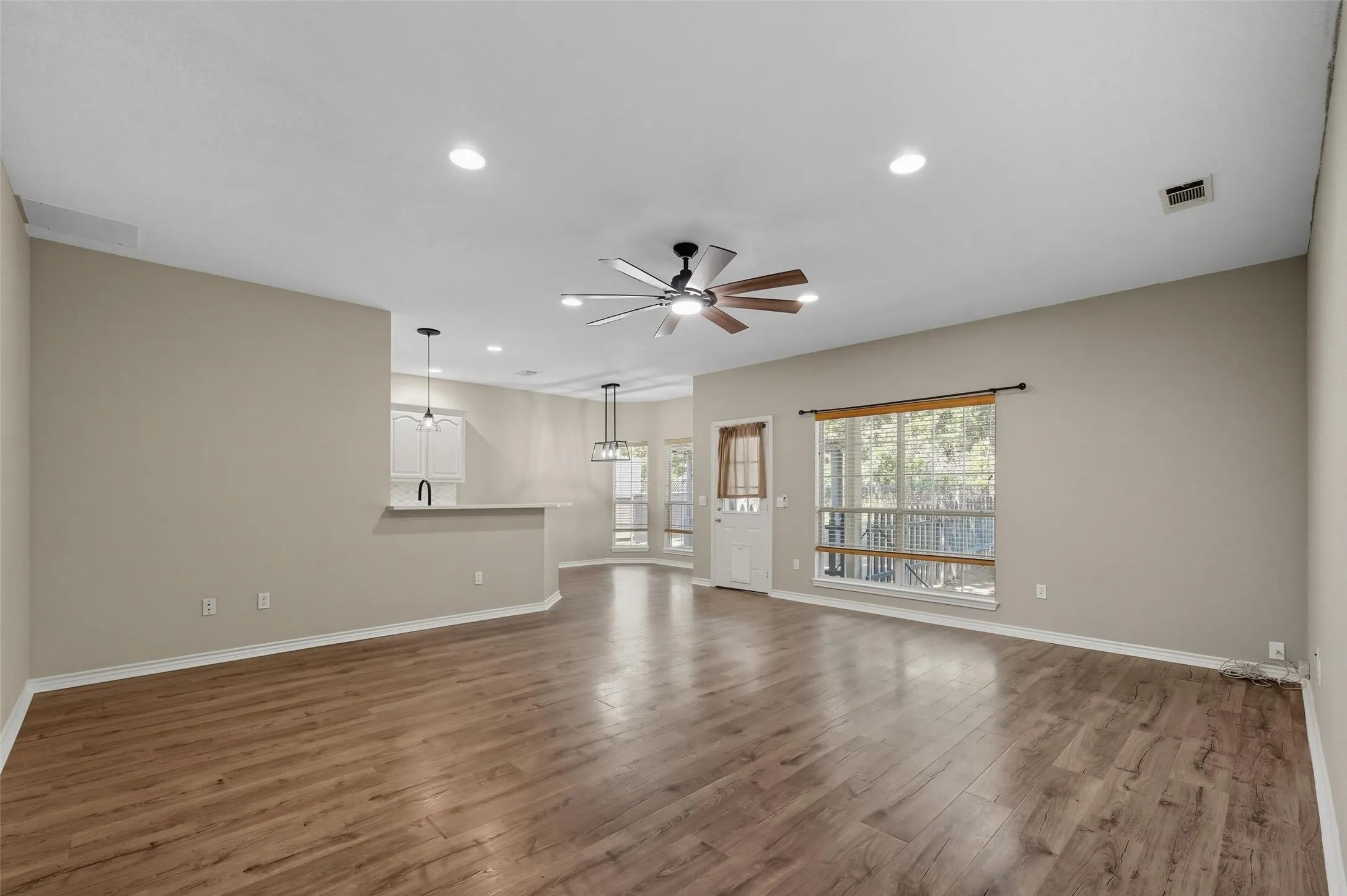 Unfurnished living room featuring wood finished floors, recessed lighting, and ceiling fan