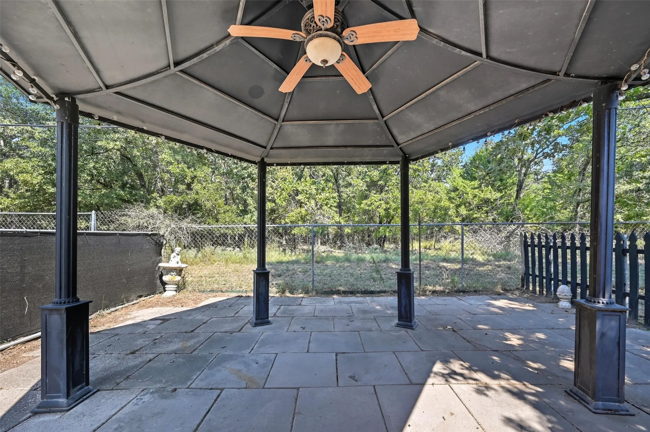 Fenced backyard with a patio area and a gazebo