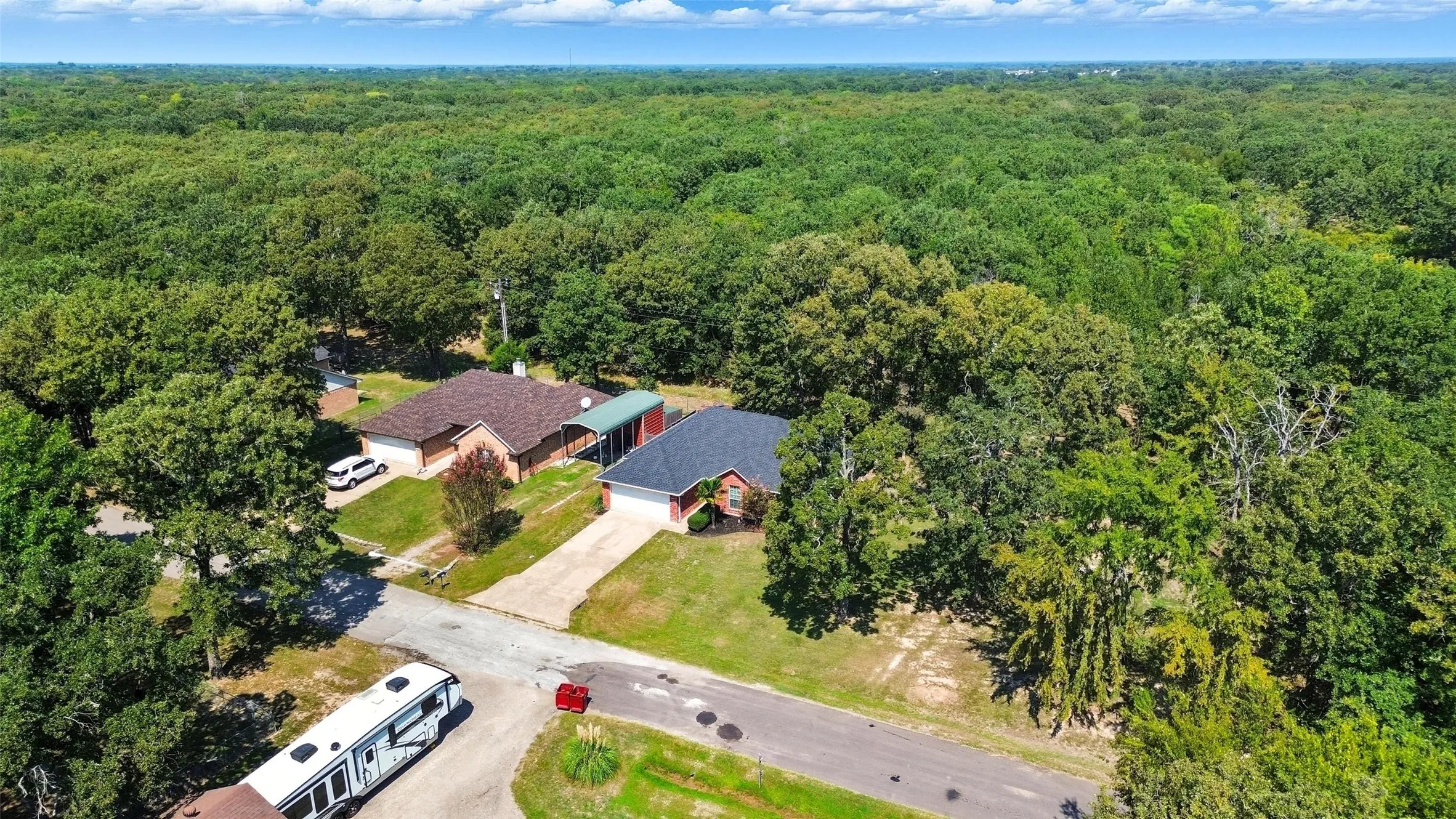 Aerial view of property with woods on the rear of home