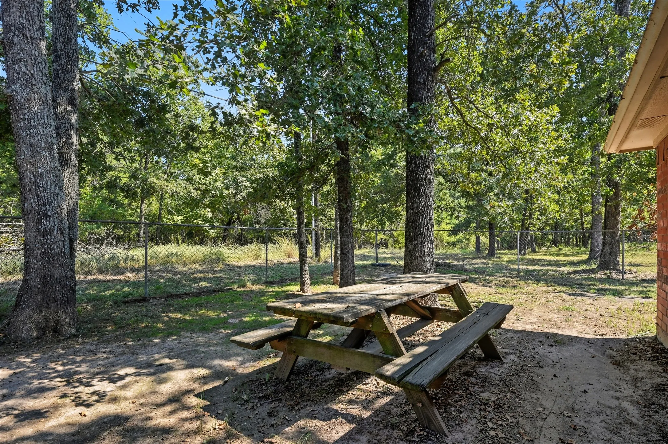Back yard with picnic table backs up to wooded land