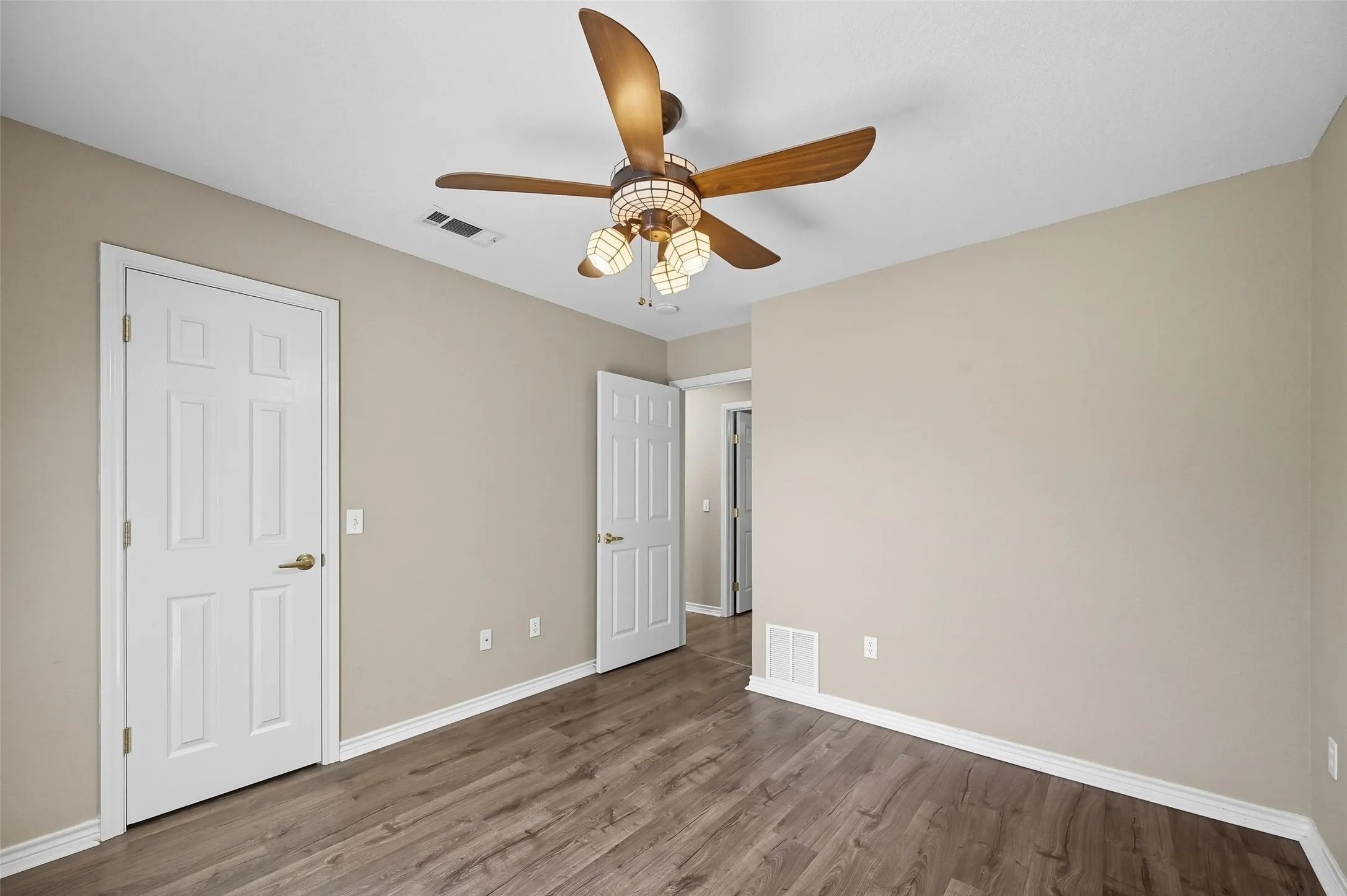 Unfurnished bedroom with wood finished floors and ceiling fan