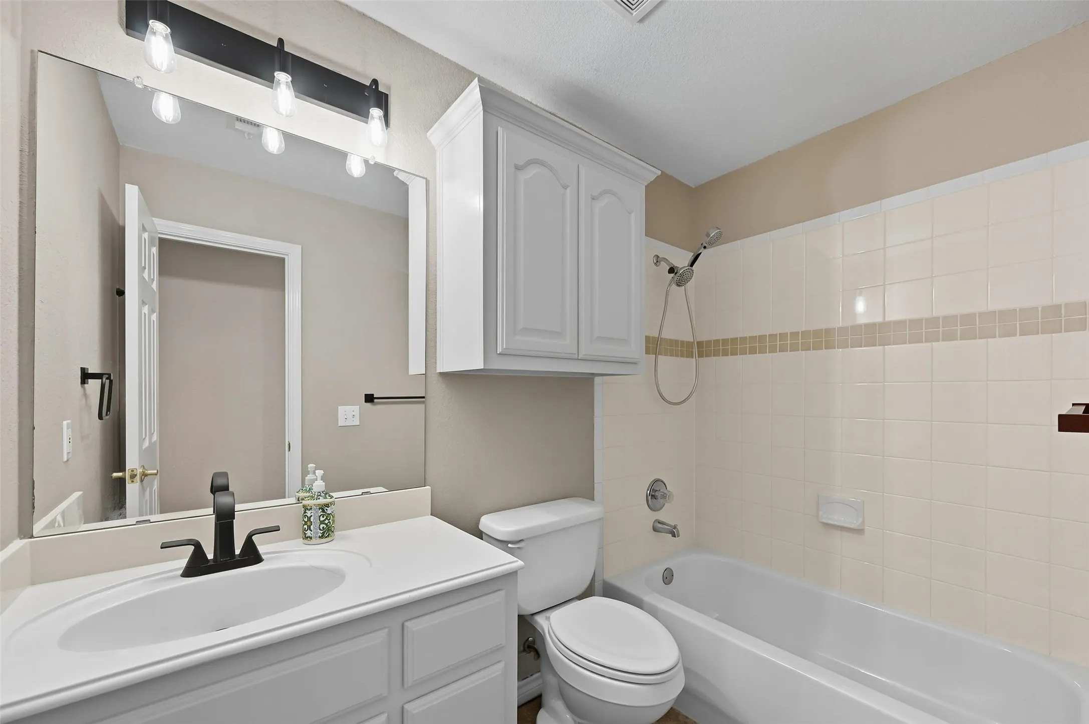 Full bathroom with bathing tub / shower combination and vanity