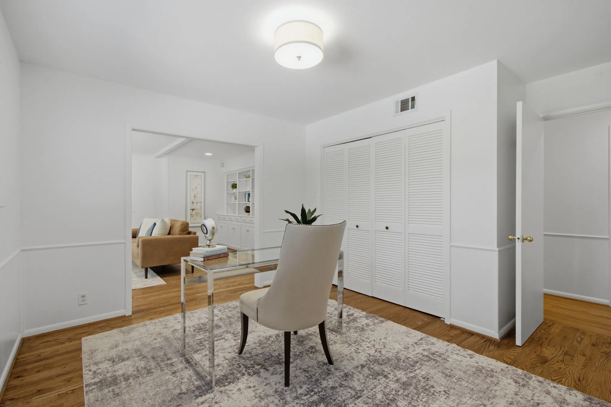 Interior room featuring wood-finish flooring and white wainscoting