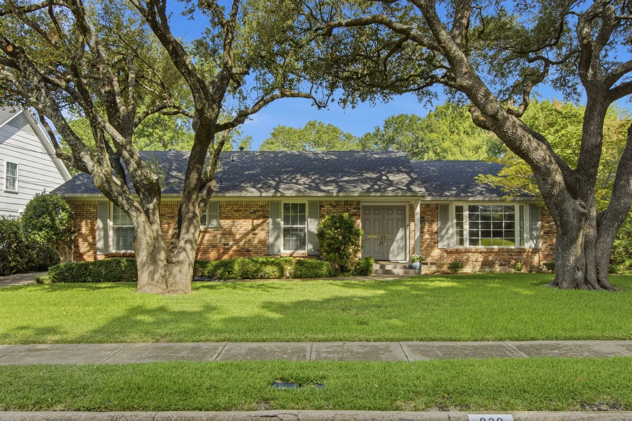 Brick ranch-style residence with mature trees!