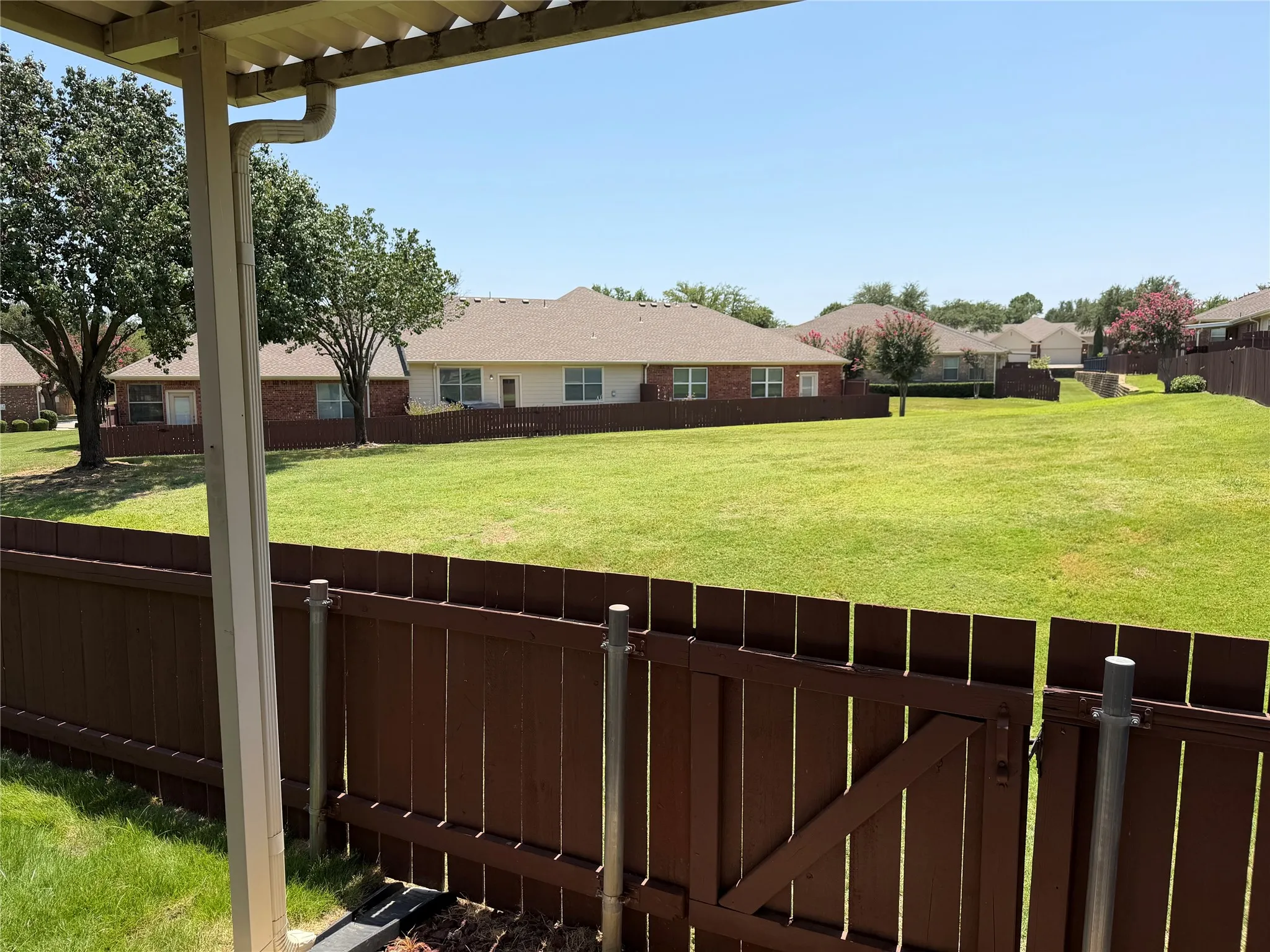 View from covered patio to large green area