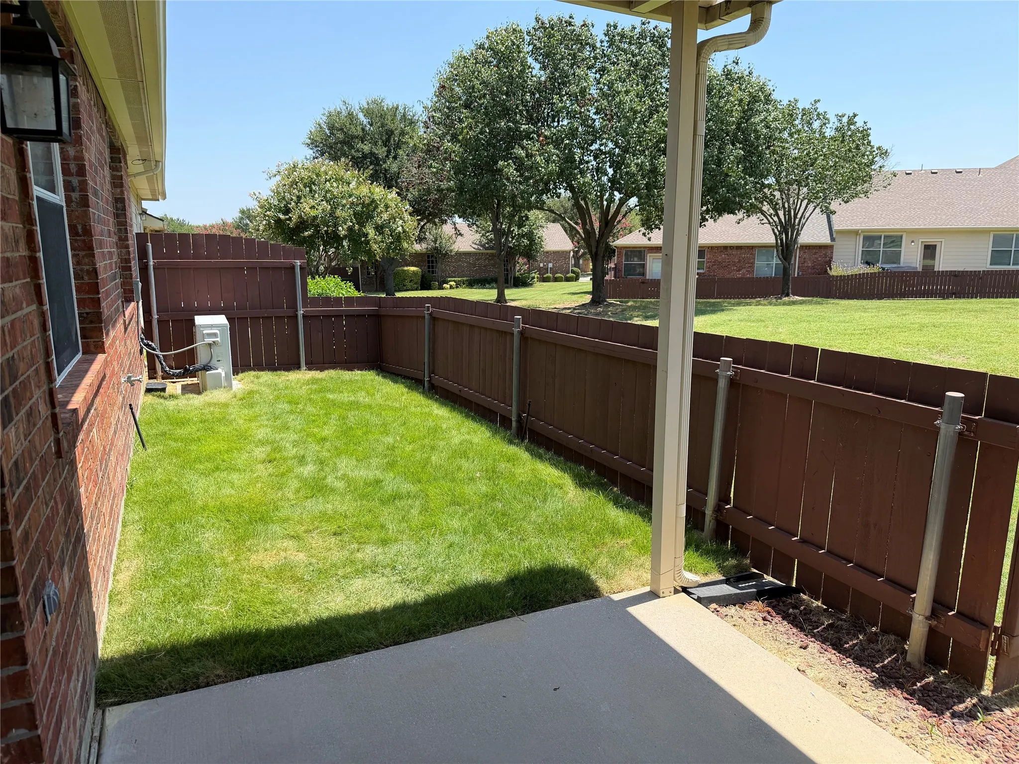 Backyard area with covered patio.