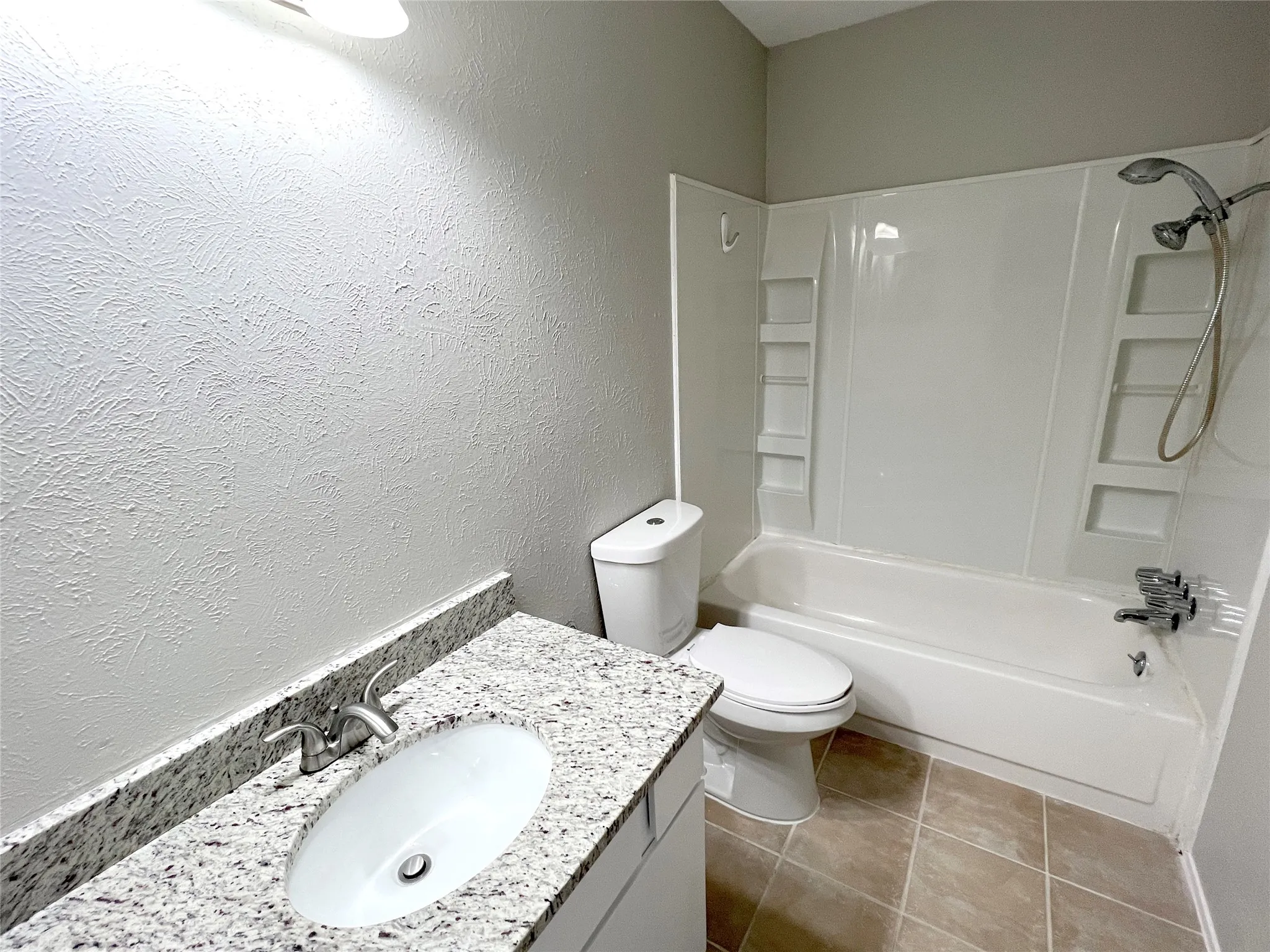 Full hall bath has granite counters