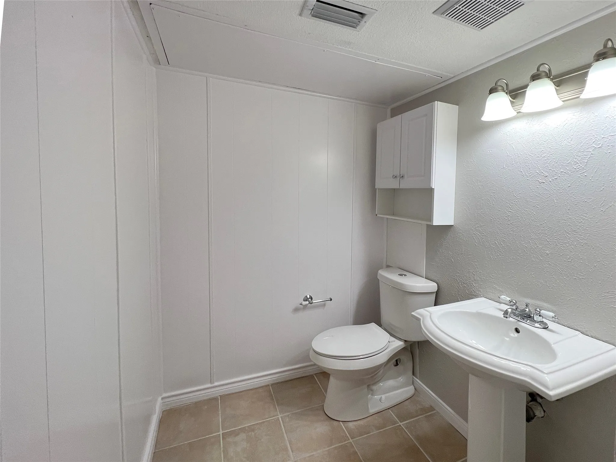 Large half bath has linen cabinets - mirrors to be installed