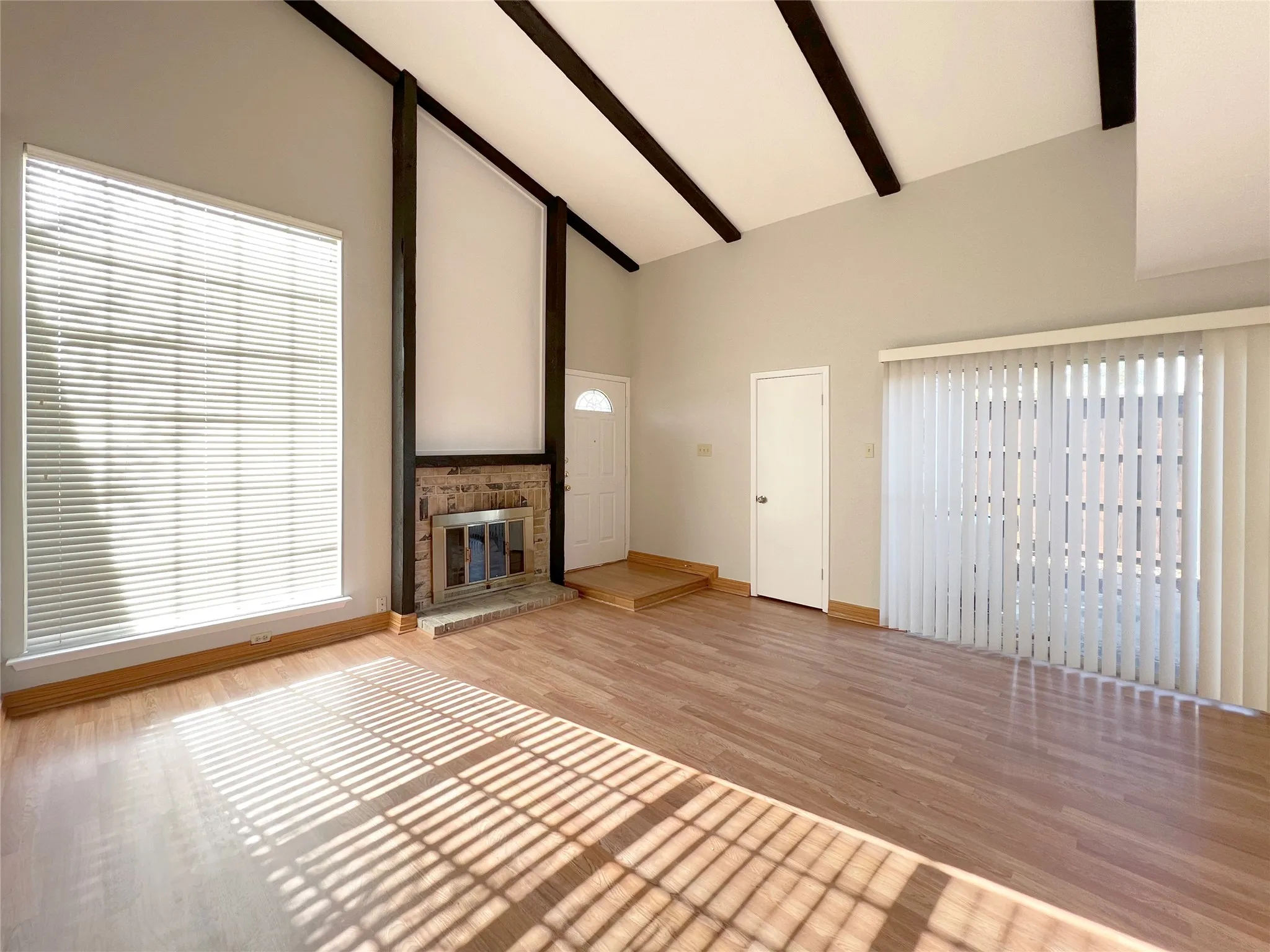 Fireplace, vaulted ceiling and door to patio