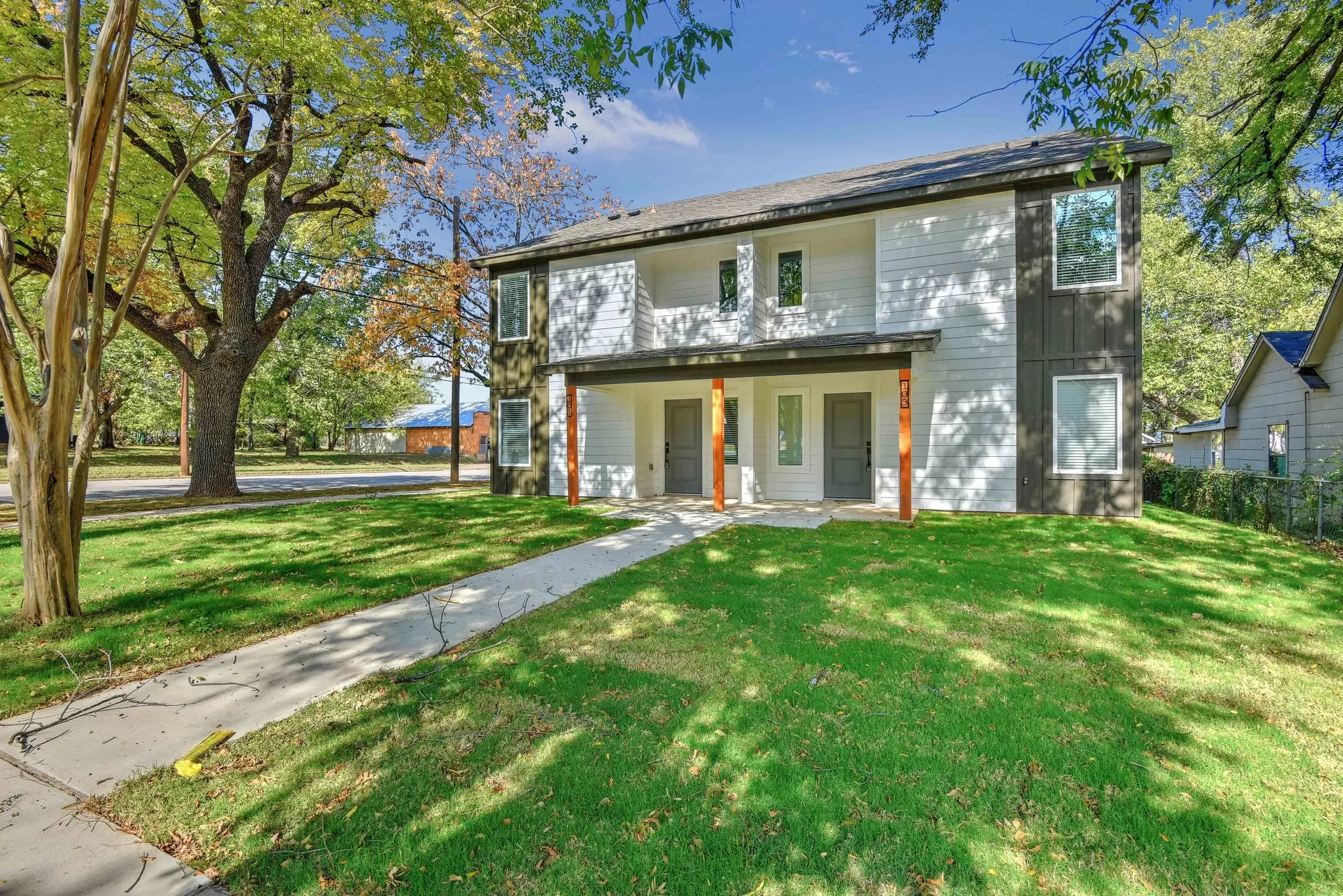 Back of house featuring a yard and covered porch